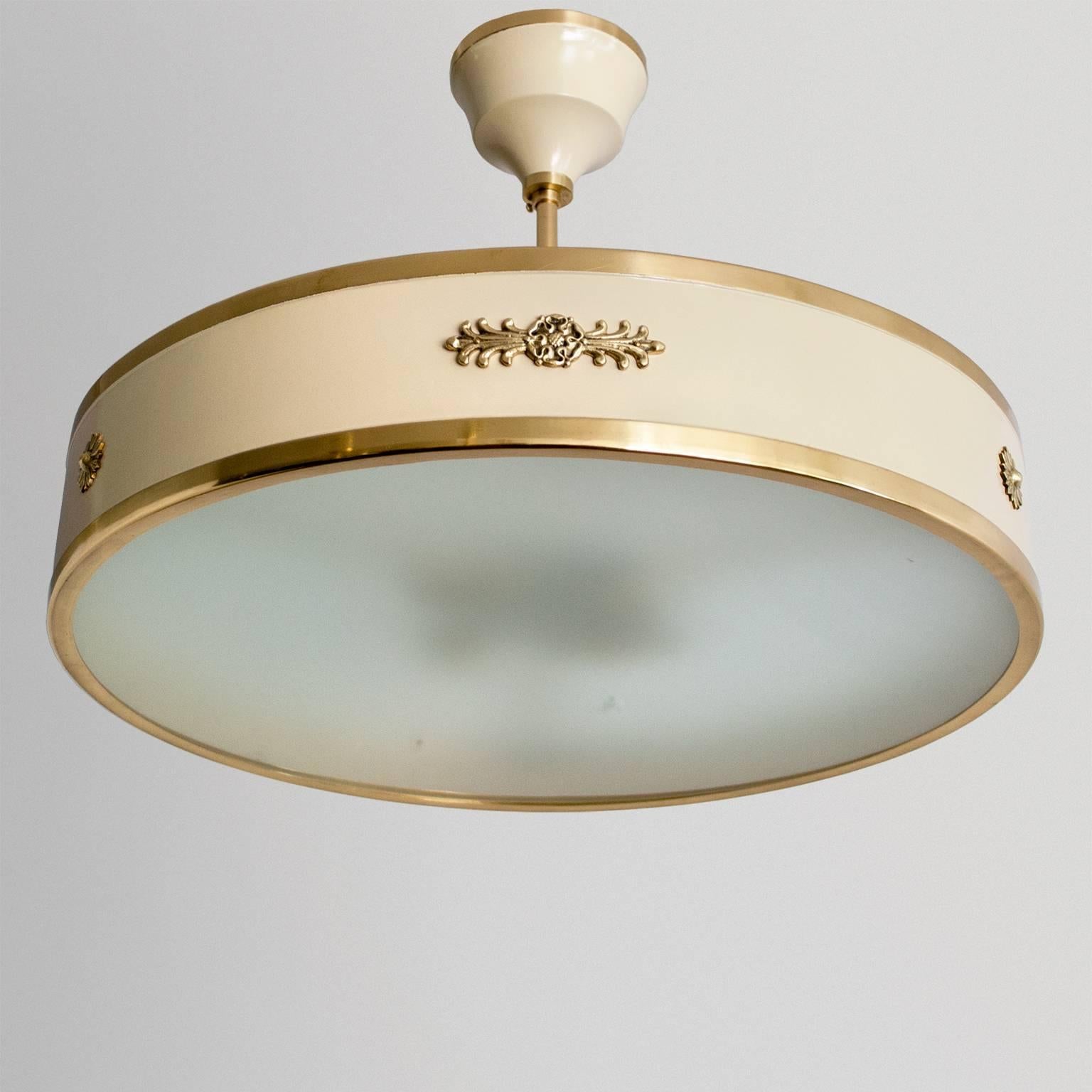 Scandinavian Modern art deco ceiling fixture with lacquered frame and details in polished brass, original acid etched glass shade. Decorative palmettes and rosettes reference classicism around the sides. Restored in excellent condition, newly wired