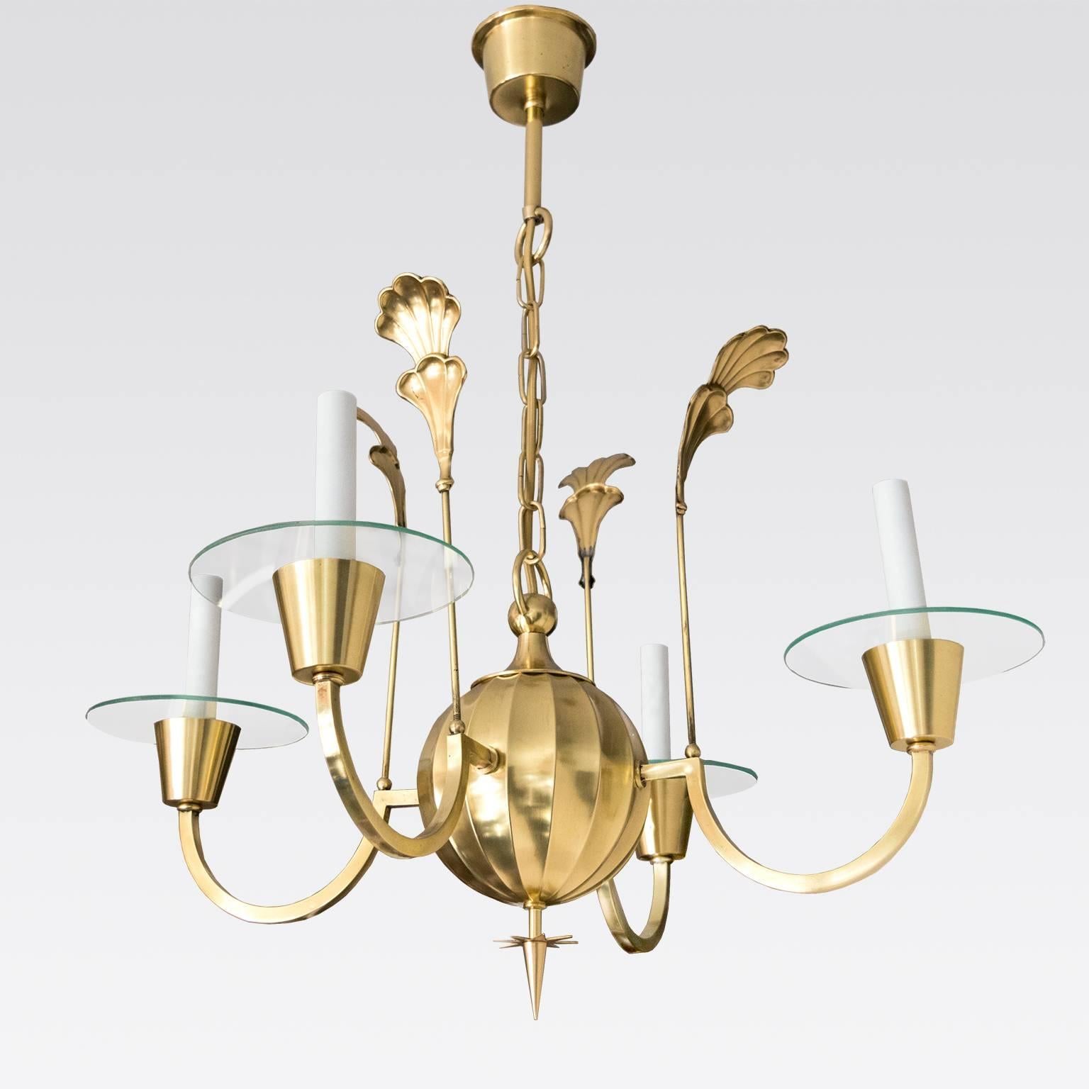 An elegant Swedish Art Deco, Scandinavian Modern polished four-arm brass chandelier designed by Elis Bergh for C.G. Hallberg silversmith, Stockholm. Newly restored and electrified with candelabra base bulbs, each arm has a clear glass bobeche. Made
