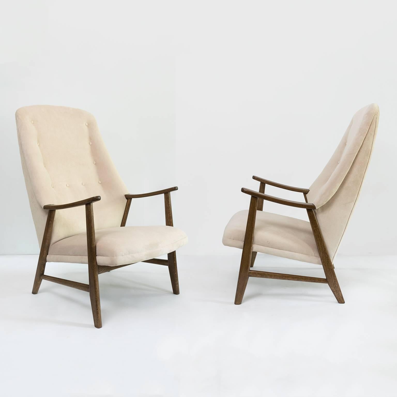 Scandinavian Modern pair of high back stained teak armchairs. Chairs have newly restored frames and off white velvet upholstery. Made in Denmark, circa 1950s. Measures: Height 42