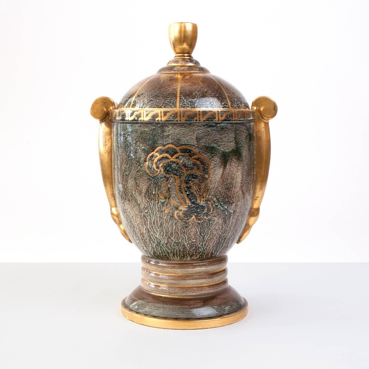 Impressive and rare Swedish Art Deco ceramic covered urn in green and gold luster glaze hand decorated with gold. Designed by Josef Ekberg for Gustavsberg, dated 1933. Excellent condition. Measures: Height 16