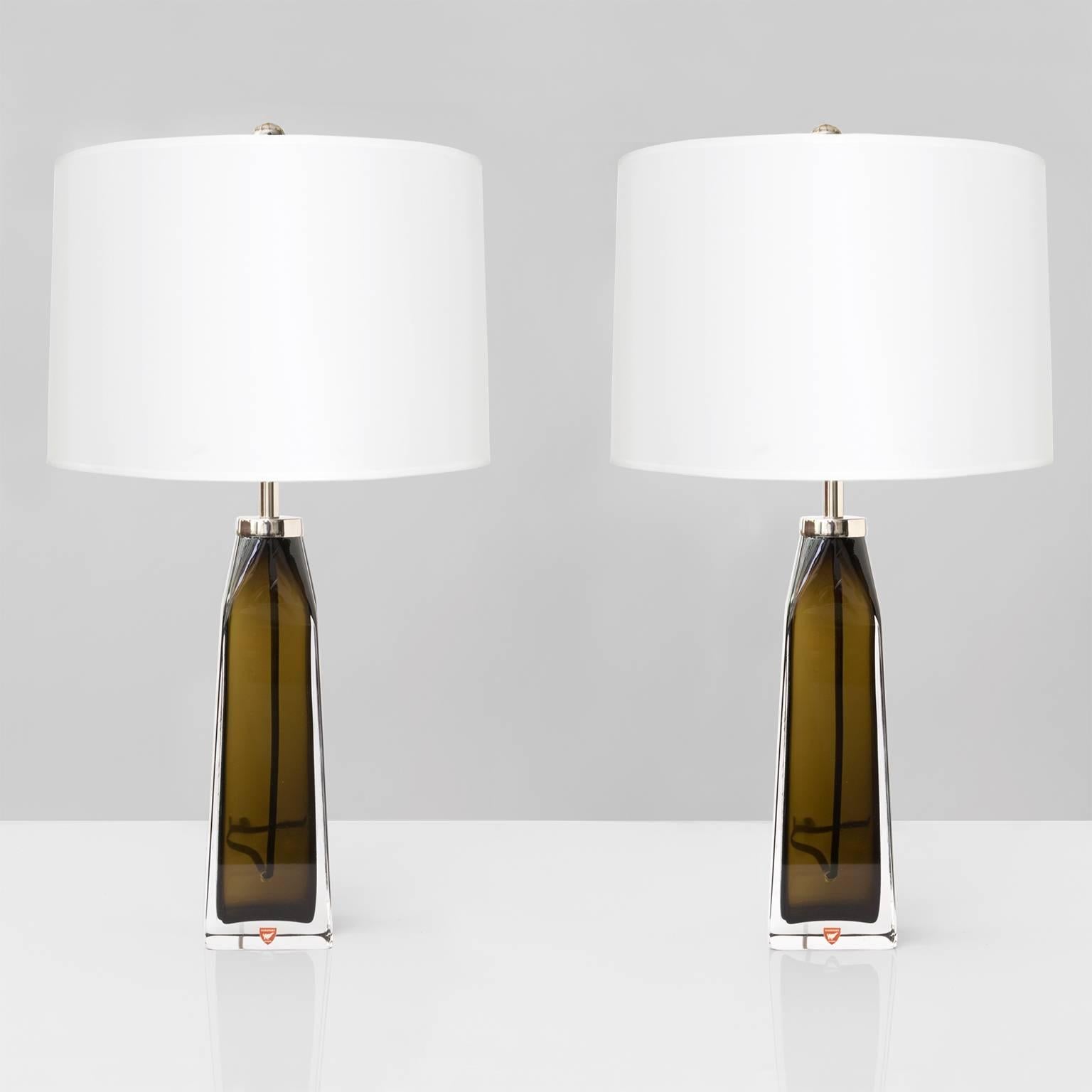 Pair of Scandinavian Modern cased crystal glass table lamps designed by Carl Fagerlund for Orrefors. Lamps have been rewired and fitted with high quality polished chrome double cluster hardware each with two standard Edison sockets for use in the