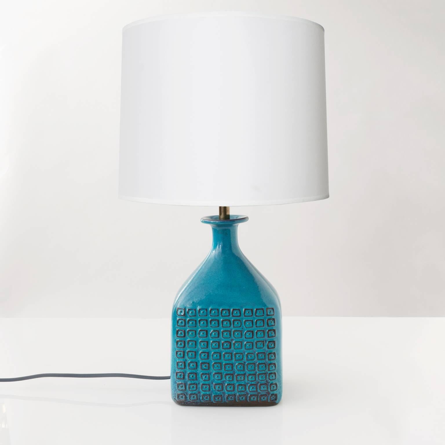 Scandinavian Modern unique ceramic lamp by Stig Lindberg for Gustavsberg Studio. Lamp has a lovely turquoise glaze and a grid of dotted squares on it's front and back facades. Newly rewired with custom patinated brass stem and double cluster,
