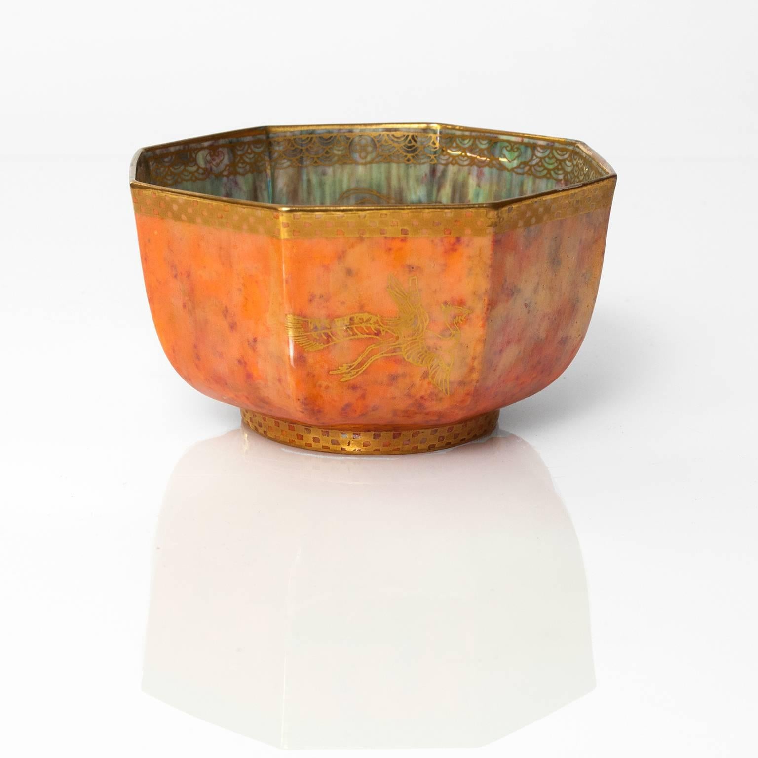 A finely decorated Wedgwood fairyland lustre bowl designed by Daisy Makeig-Jones. The bowl's mottled orange exterior is decorated with gold on the inner and outside. Excellent condition. Measures: Diameter: 5", height: 2.75".

The
