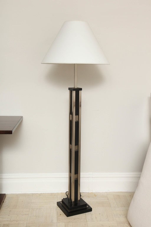 Modernist floor lamp, ebonized wood and nickel-plated steel.