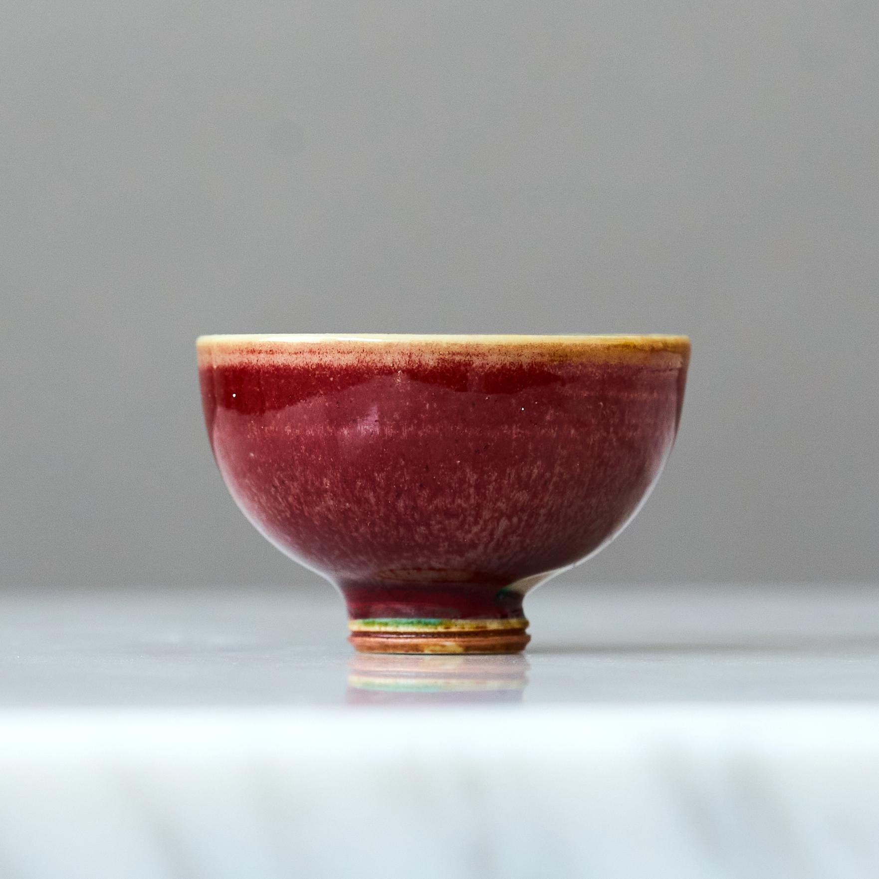 A beautiful miniature stoneware bowl with amazing glossy sang de boeuf (oxblood) glaze.
Made by master thrower Berndt Friberg, in the artist's studio at Gustavsberg, Sweden, 1960s.

Great condition. 
Incised signature 'Friberg' and Gustavsberg