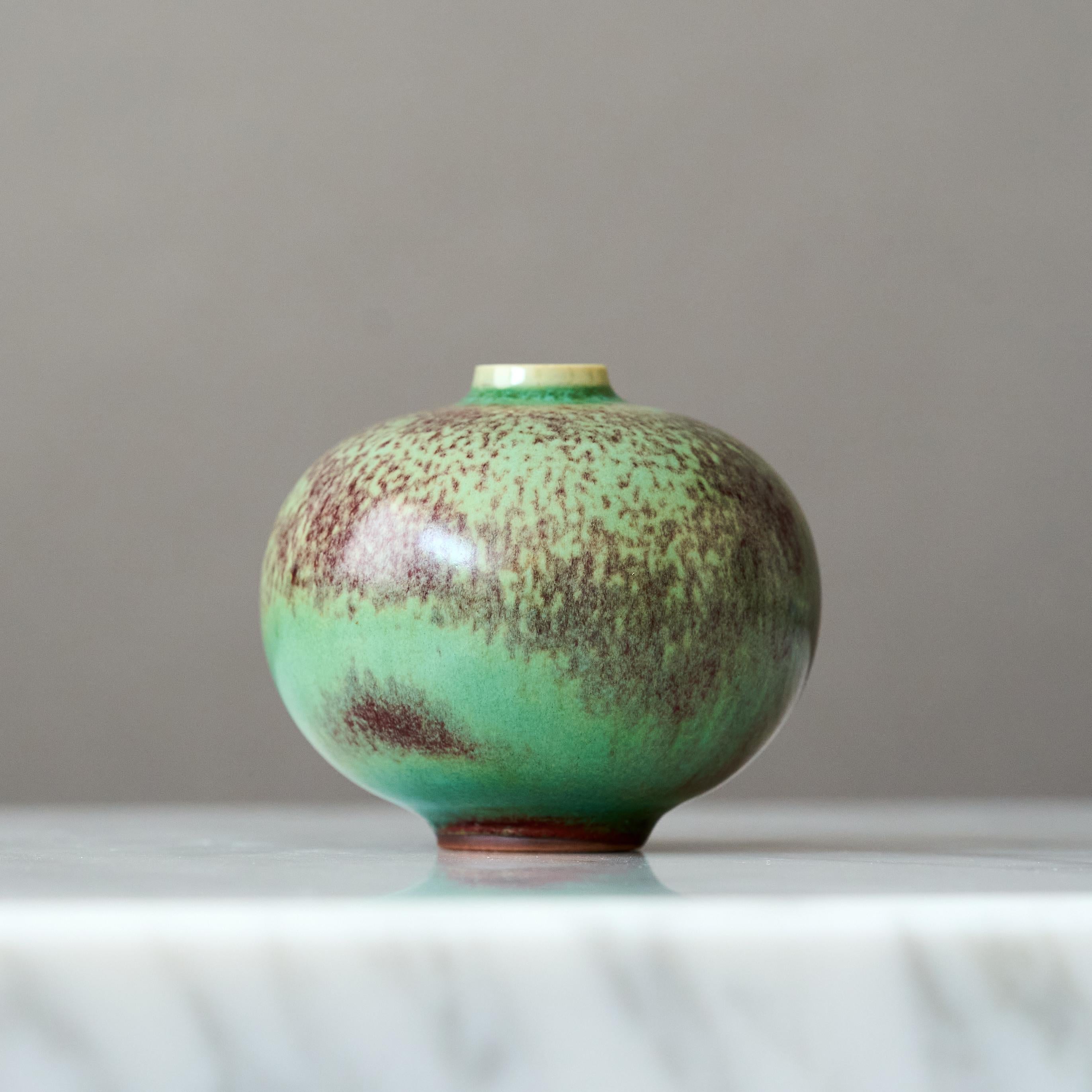 A beautiful miniature stoneware vase with amazing green and red glossy glaze.
Made by master thrower Berndt Friberg, in the artist's studio at Gustavsberg, Sweden, 1960s.

Great condition. 
Incised signature 