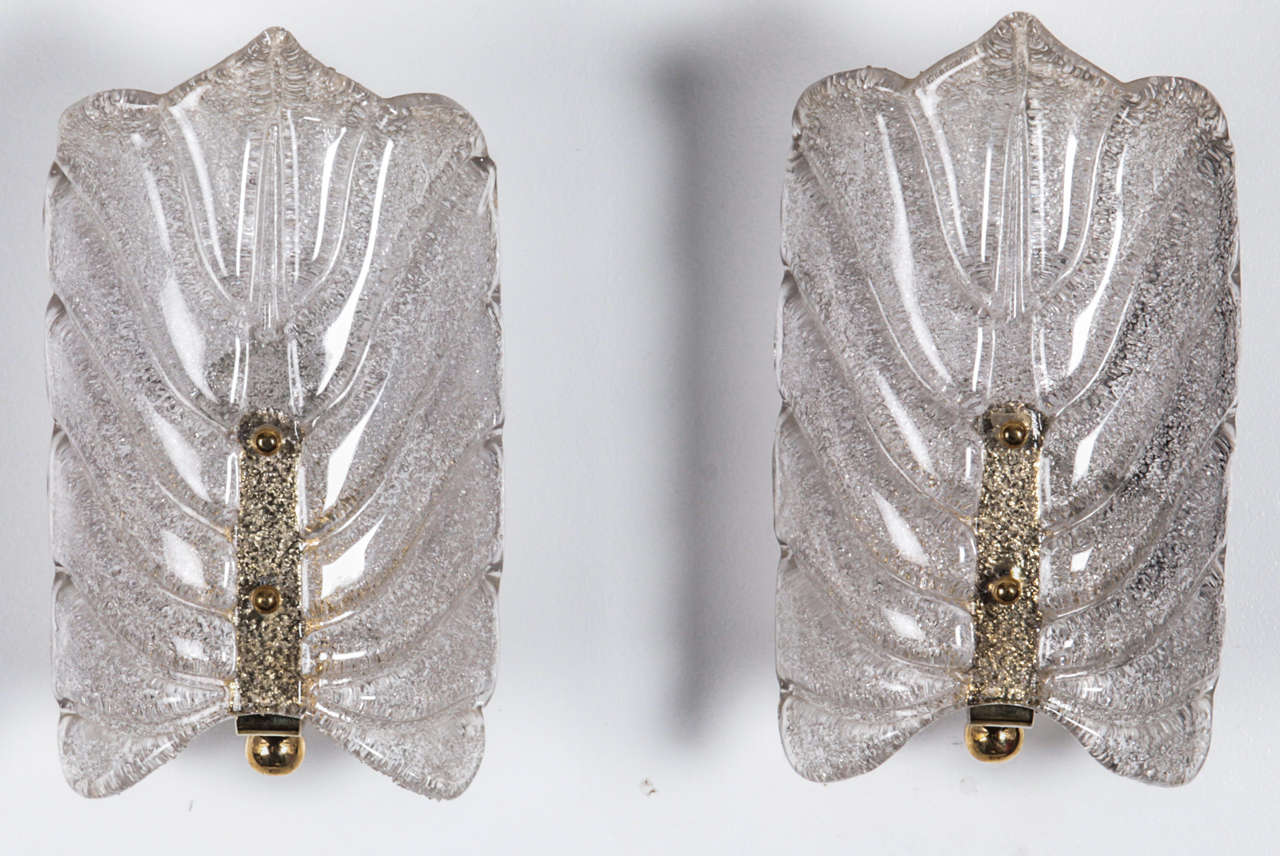 Pair of crystal stylized leaf sconces with a brass center stem by Orrefors, Sconces have been rewired for use in the USA. 

Currently 2 pairs available.