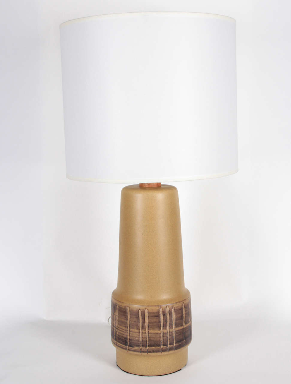 Midcentury pair of Tan glazed ceramic lamps with a contrasting glazed band detail, also with wood necks and finials by Gordon Martz. New wiring and sockets, 100W max bulbs. Shades not included.