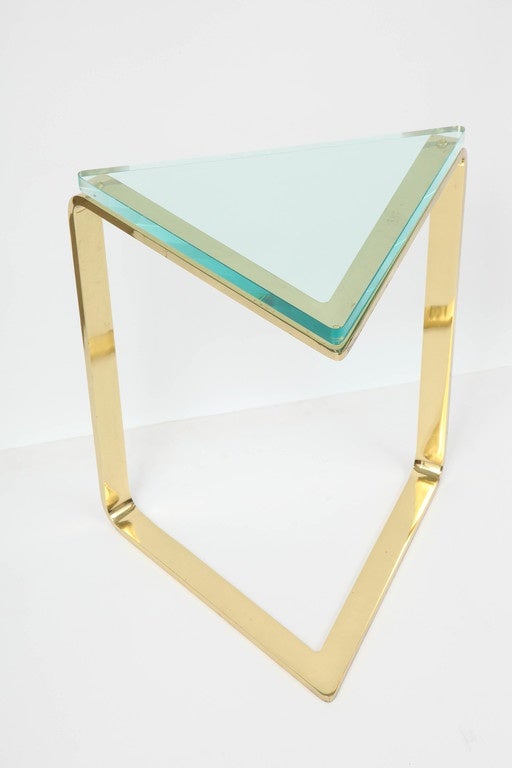 Ultra Glam 1980's polished brass triangular side table with a glass top.
