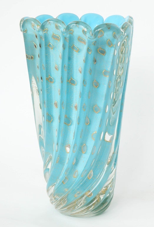 Midcentury classic triangular bouquet vase in a vibrant sky blue color with a thick swirling glass overlay utilizing a controlled bubble and gold dust inclusion application.