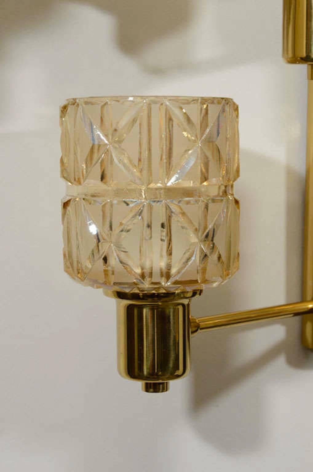 Exceptional pair of five-arm brass sconces with deep cut, light champagne crystal cups. Rewired for use in the USA.