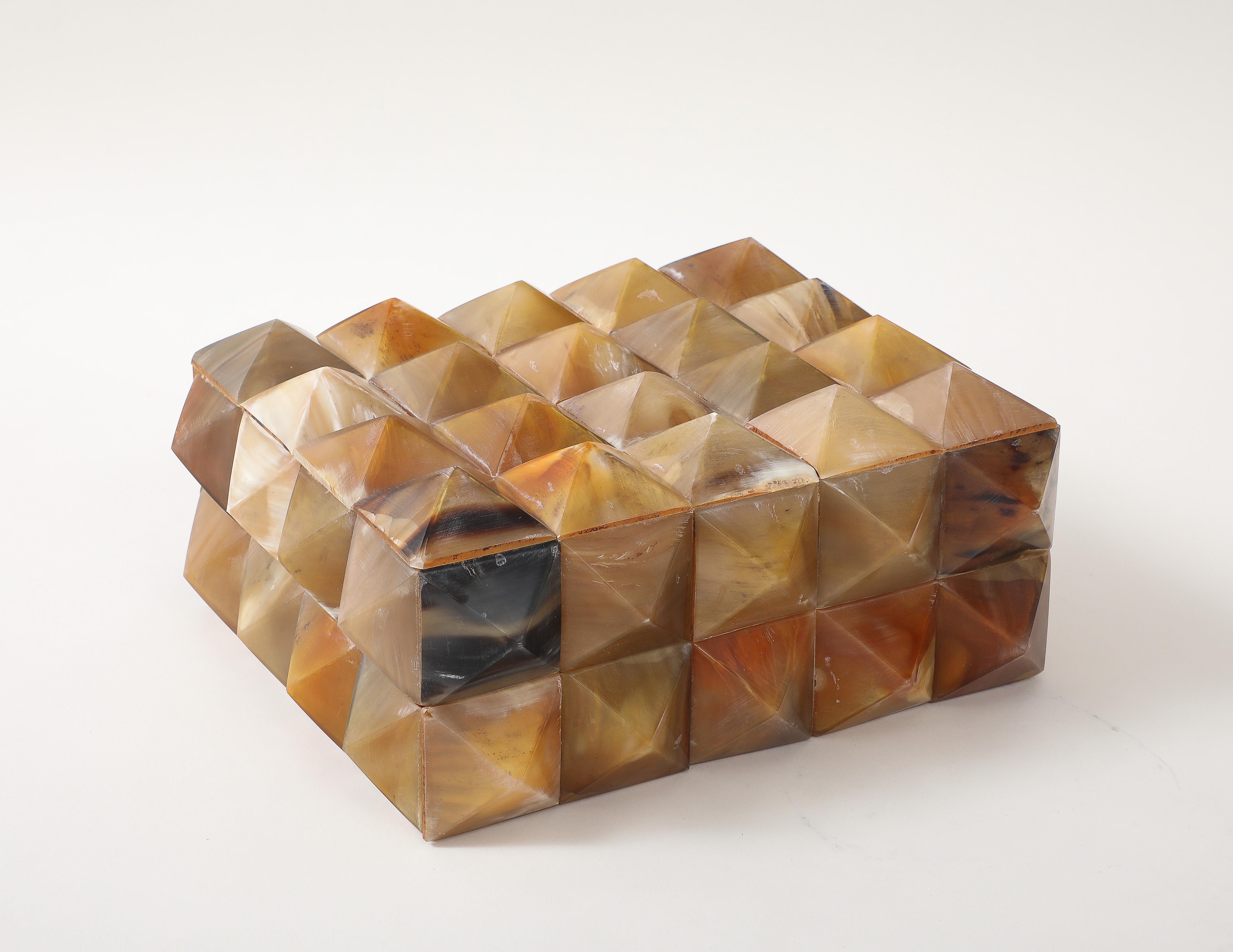 Textural keepsake box clad in heat set pyrimidial horn elements. A great addition to any desk or coffee table.
