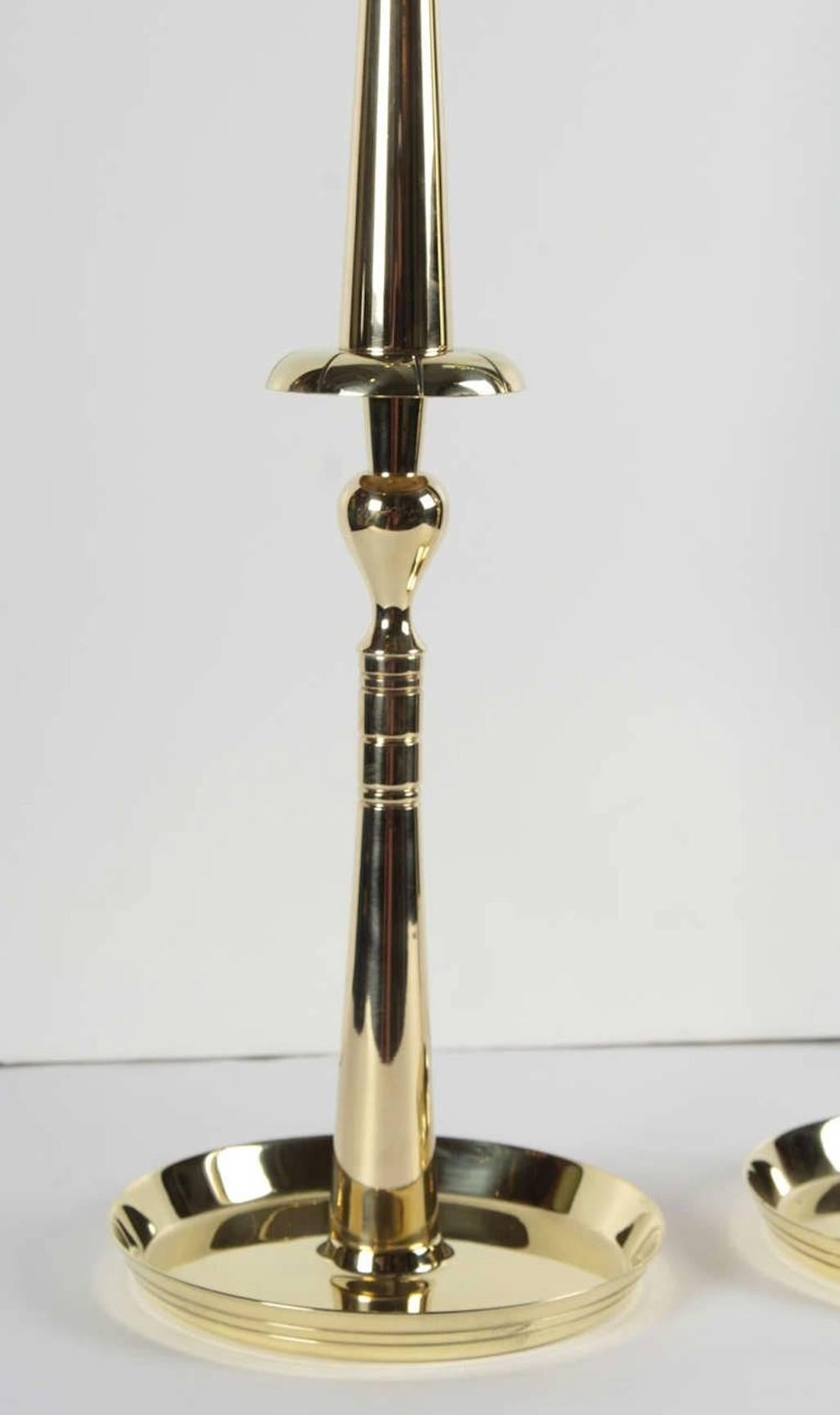 Pair of elegant brass spindle candlesticks designed by Tommi Parzinger.