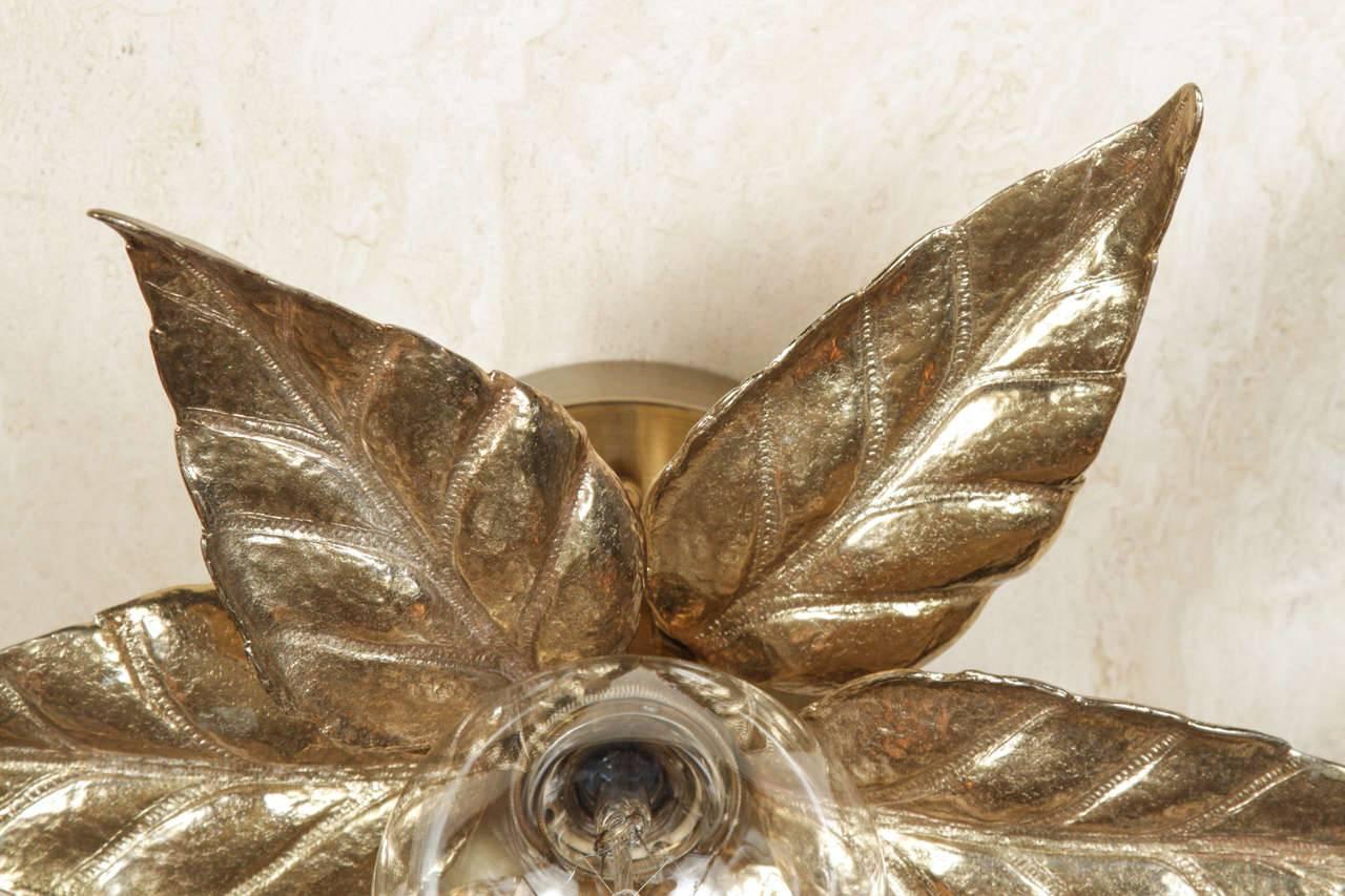 Pair of eye-catching gilt washed stylized flower sconces with one central light source surrounded by six large petals. Uses one Edison type socket. 

There are currently two pairs available.