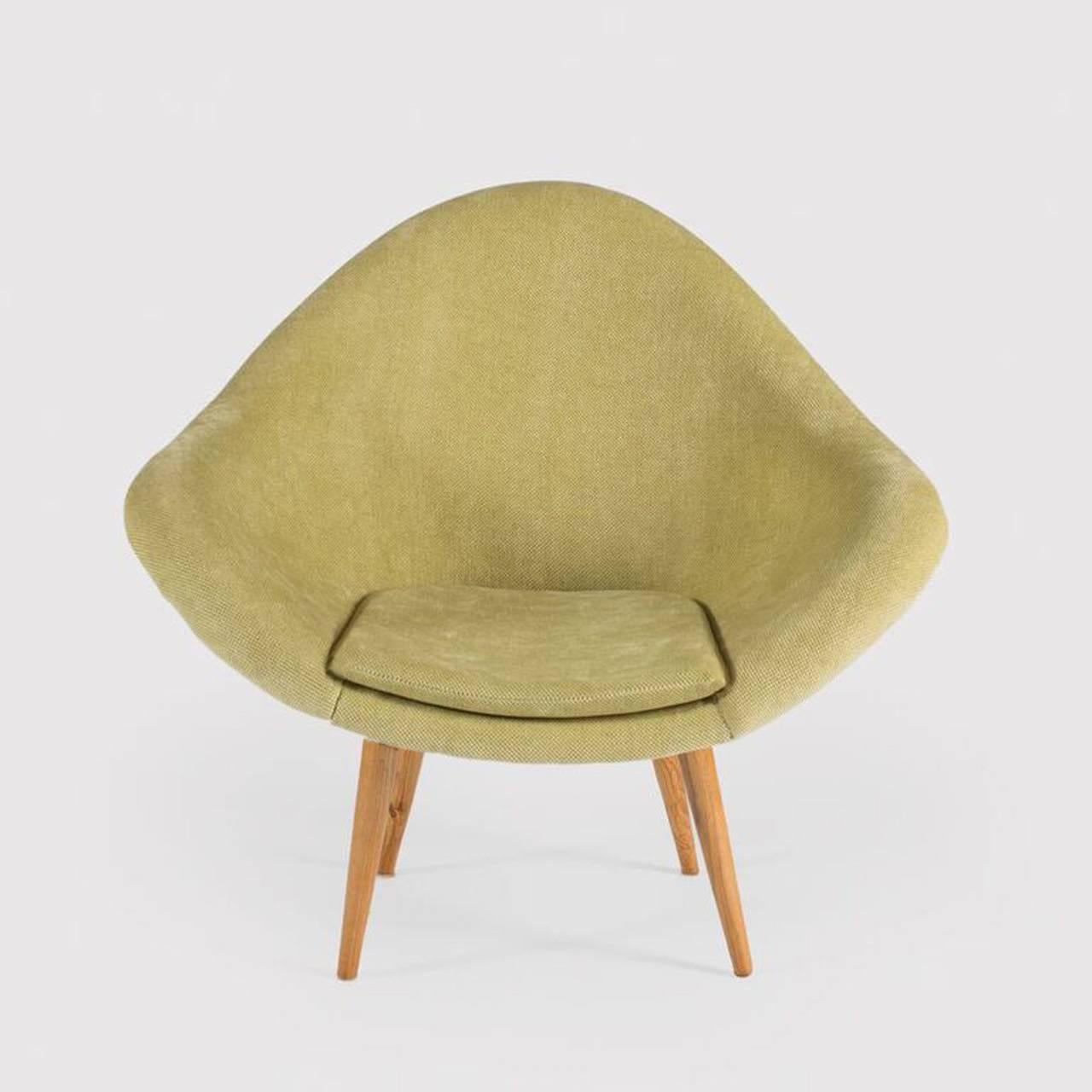 A single armchair by Chech iconic designer Miroslav Navratil, manufactured by Developmental Furniture Industry- Brno. Beech legs with black painted metal fittings. Fiberglass shell newly upholstered in light green fabric.