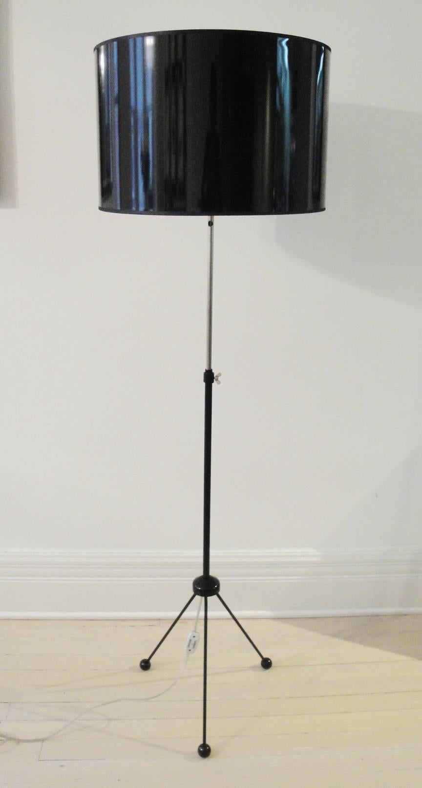 Fully restored black enameled metal tripod lamp. Painted wood feet, metal structure and new high gloss lacquered black shade. Hight is adjustable, maximum 62