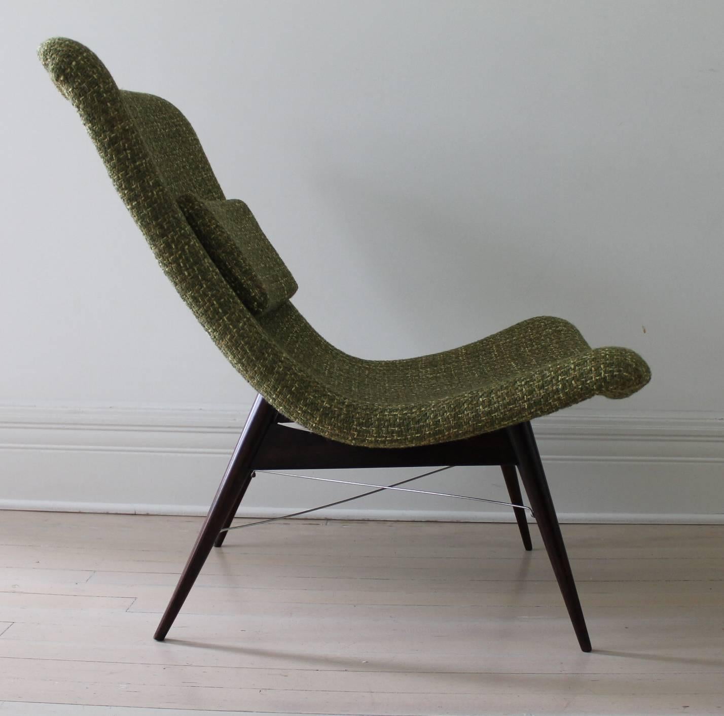 Easy chair by Miroslav Navratil, manufactured in Czech Republic by Cesky Nabytek, 1959. Dark walnut base, light gray fiberglass shell, newly upholstered seat with a fabric from the period. Removable pillow on leather straps.