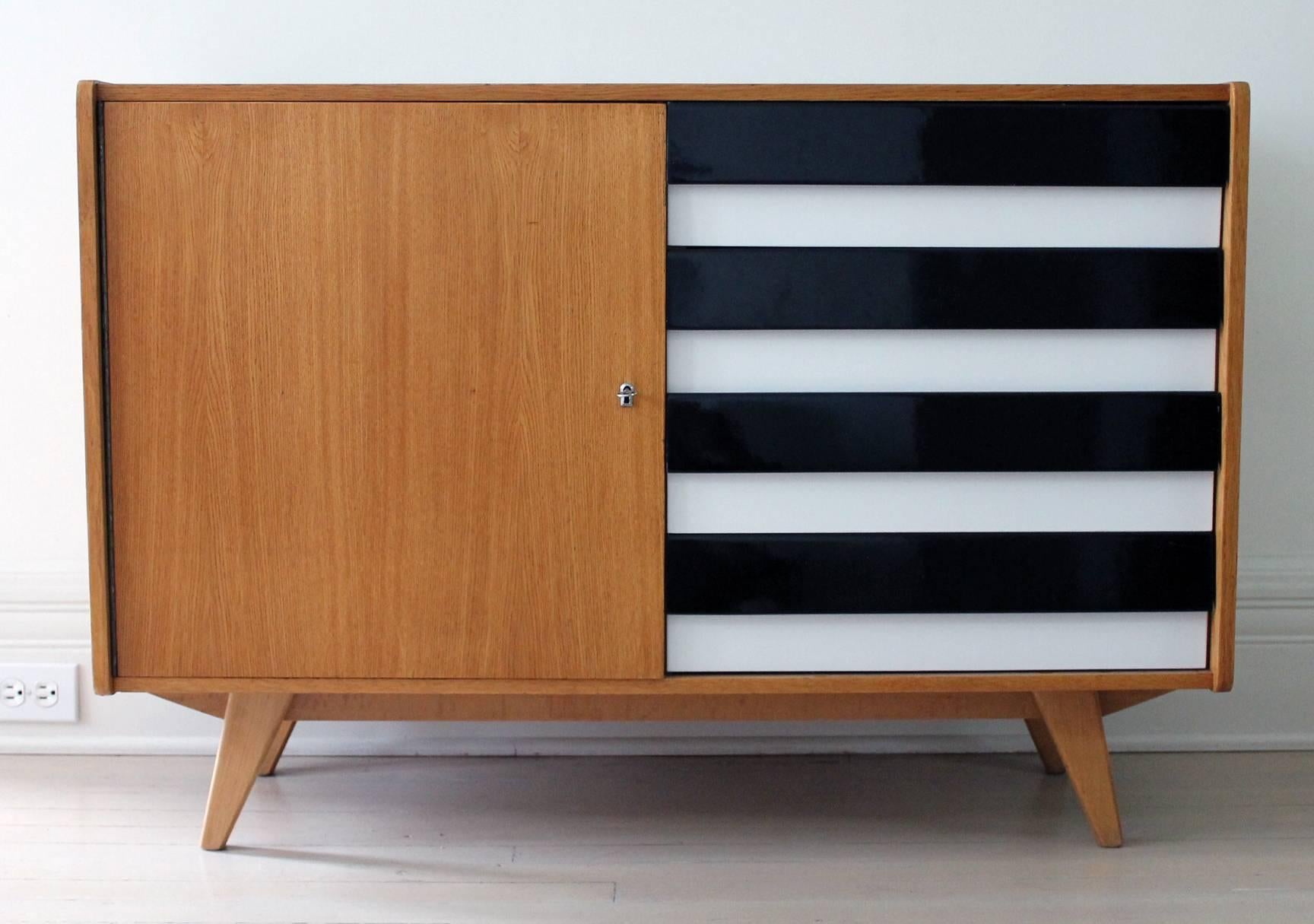 Ash credenza designed by Jiri Jiroutek for Interier Praha. High gloss black and white painted wood drawers four (4) on one side and doors with a locked compartment on the other side.