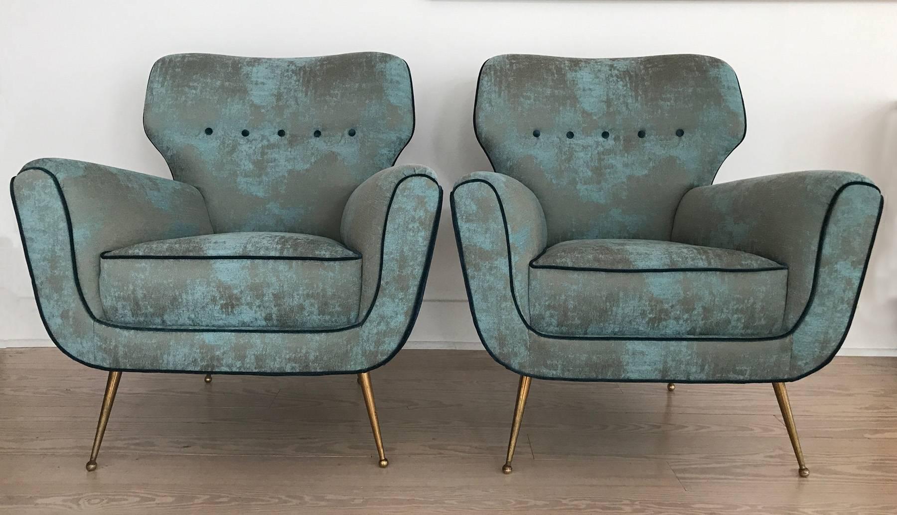 Spectacular yet comfortable Italian lounge chairs with curved silhouette frame. Newly upholstered in light blue and gold, velvet-like fabric from the period. Brass spiked legs have some patina. The chairs have been restored and reupholstered.