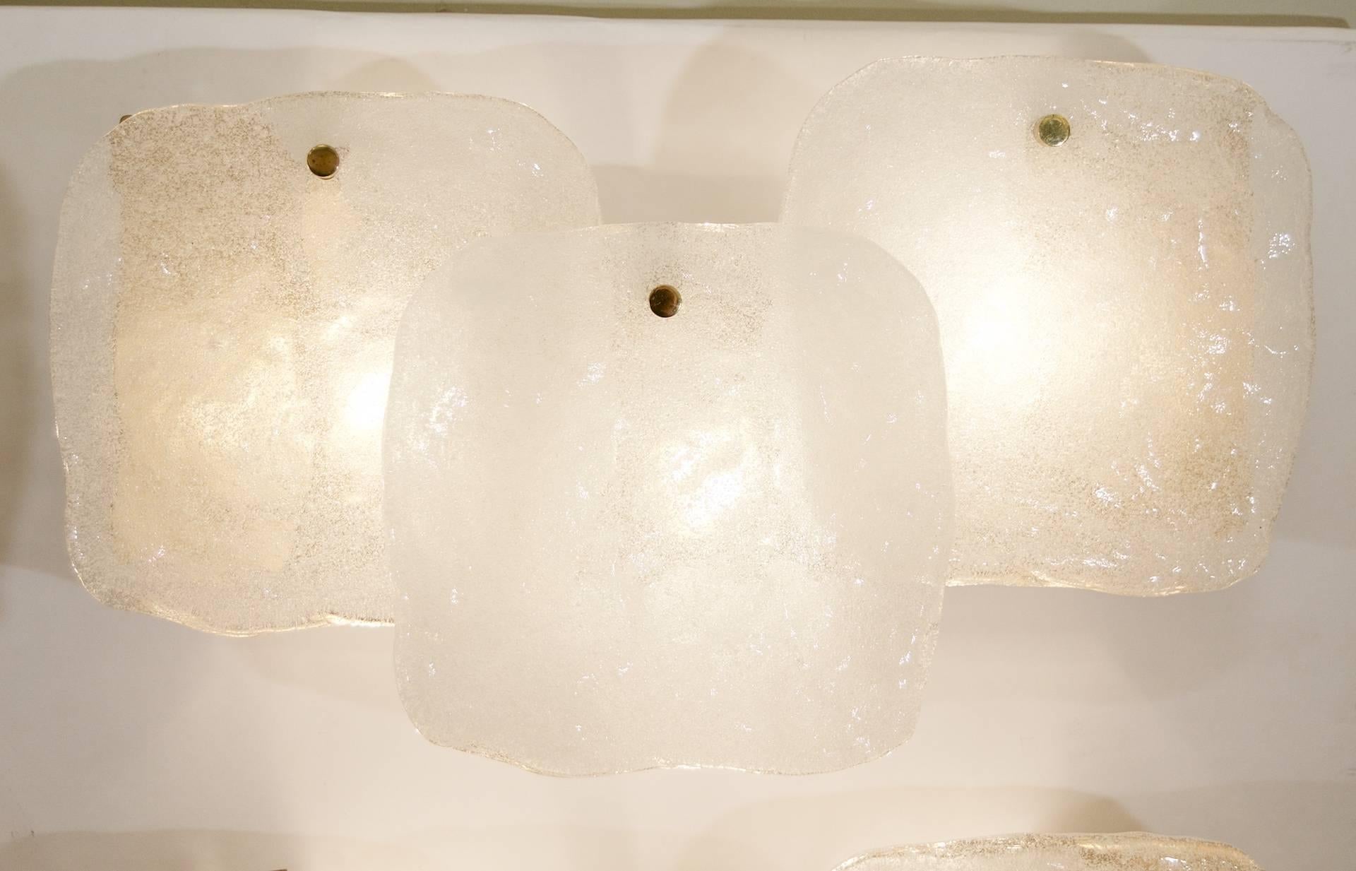 An excellent pair of large Kalmar wall sconces, each having three large pieces of ice block glass hung in a staggered fashion from a gold tone enameled backplate.

Three E-14 base bulb up to 40 watts per sconce, new wiring.

Price listed is per