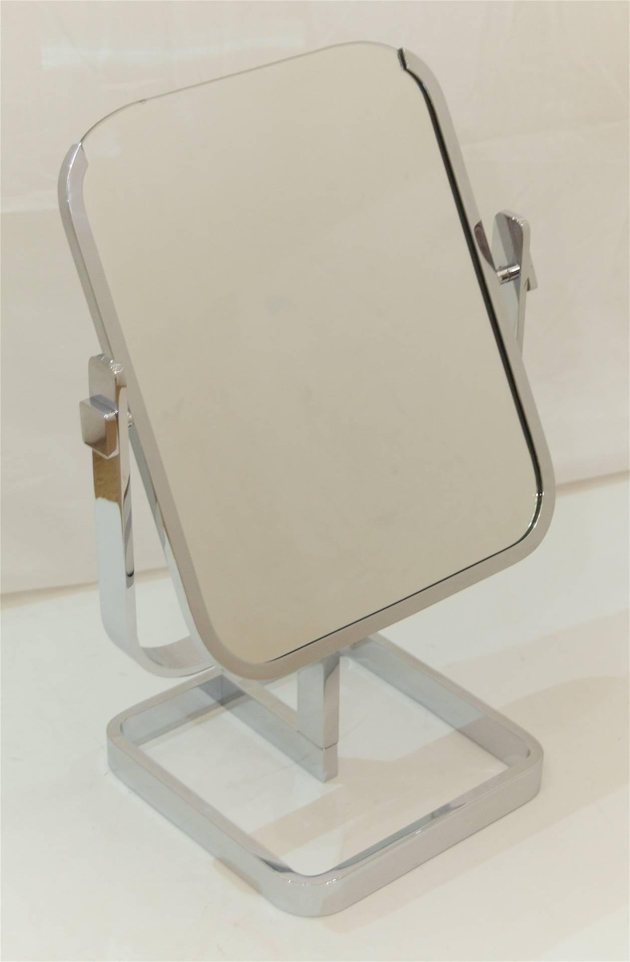 Well-sized vintage department store tabletop vanity mirror, the double-sided mirror mounted in a chrome rail on three sides and supported by a yoke base.