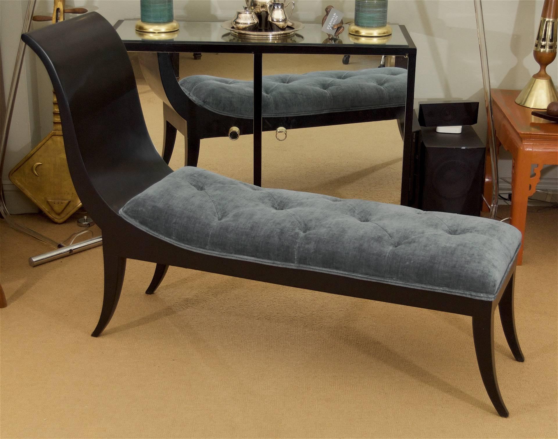 A stylish early 20th century French Art Deco period chaise with streamlined sabre legs and a streamlined back; newly refinished in satin black lacquer and reupholstered in minimally tufted soft stone blue velvet.

Comfortable and conveniently