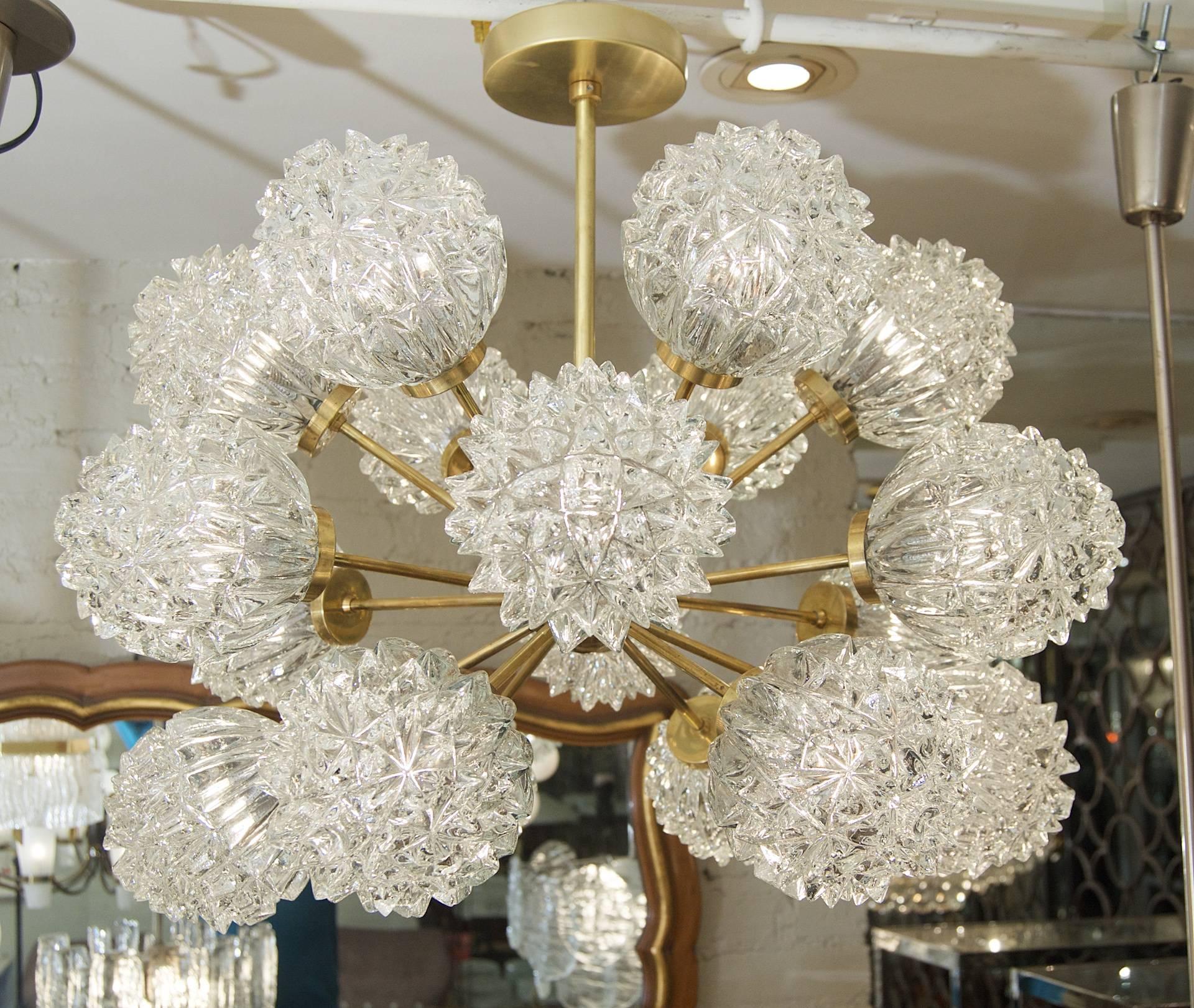 This unique Sputnik chandelier features 18 angular glass globes on a brass fixture.

Height is of chandelier body only current height as hung is 20