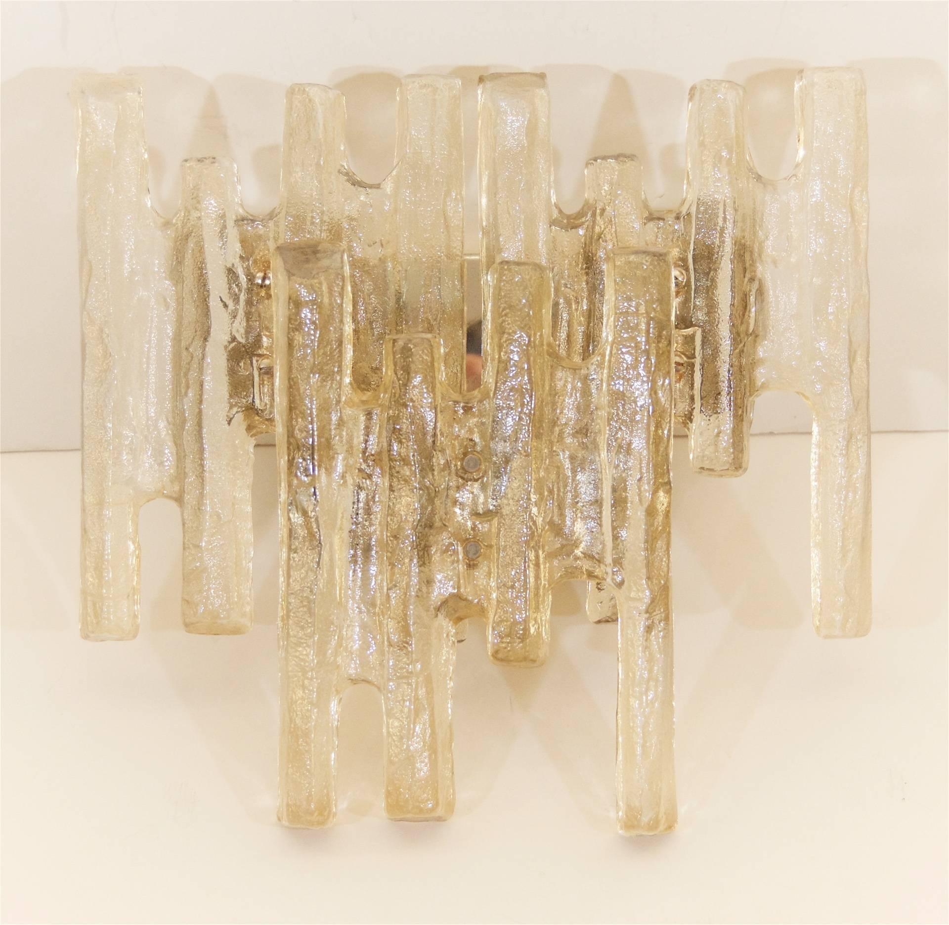 A dramatic Kalmar ice glass sconce with a chrome backplate and three unusually shaped large pieces of amber toned ice glass. Perfect sizing for over a vanity. 

Each sconce takes four E-14 base bulbs, up to 40 watts per bulb. New wiring.