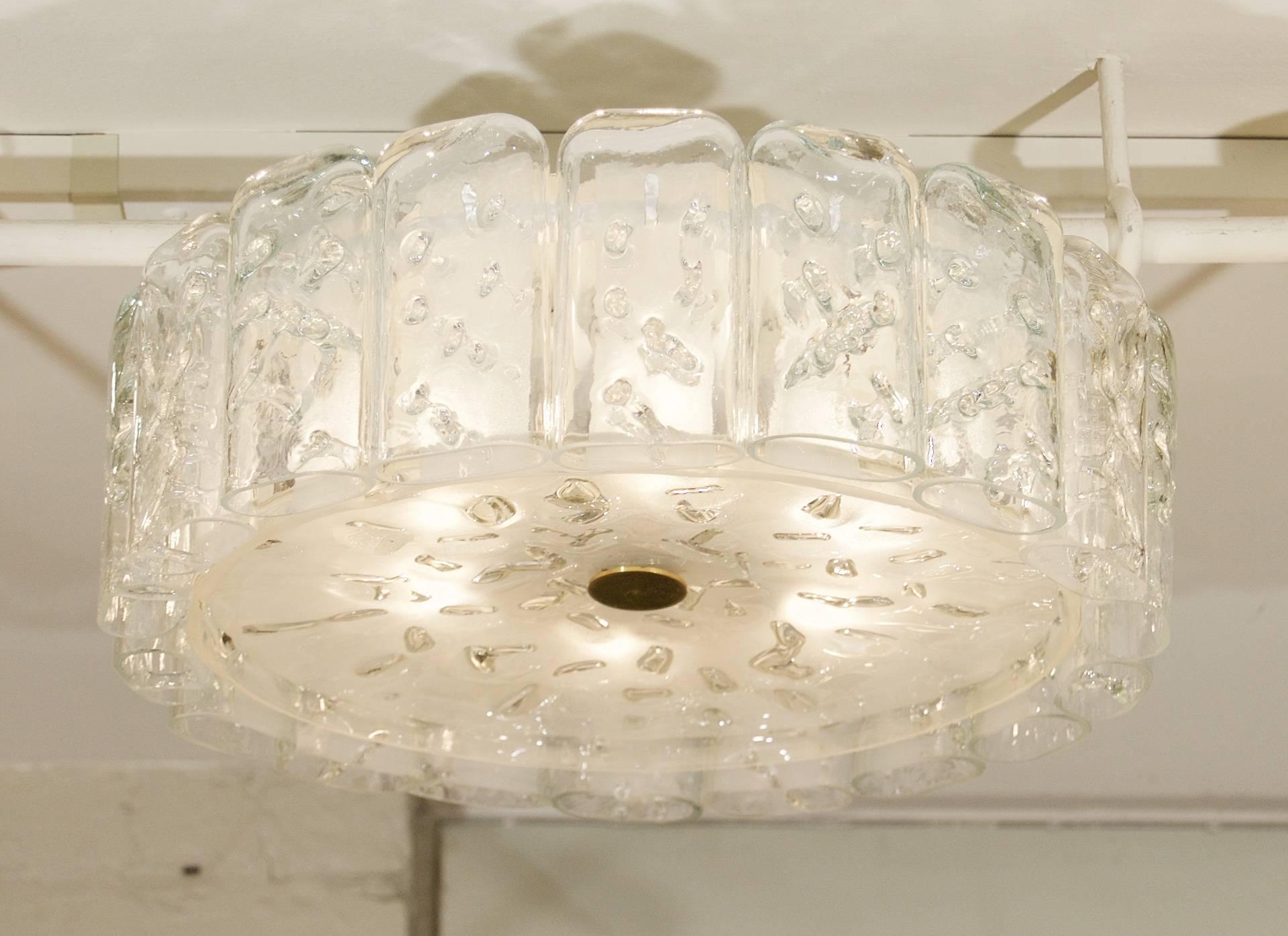Excellent Doria flush mount chandelier, the organic glass tubes surrounding a central glass disc. Brass hardware.

Takes 6 E-14 base bulbs up to 40 watts per bulb, new wiring
