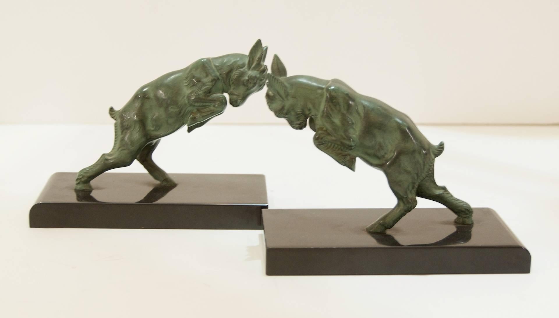Excellent pair of early 20th century bronze on marble bookends in the form of two leaping or butting head ibexes.