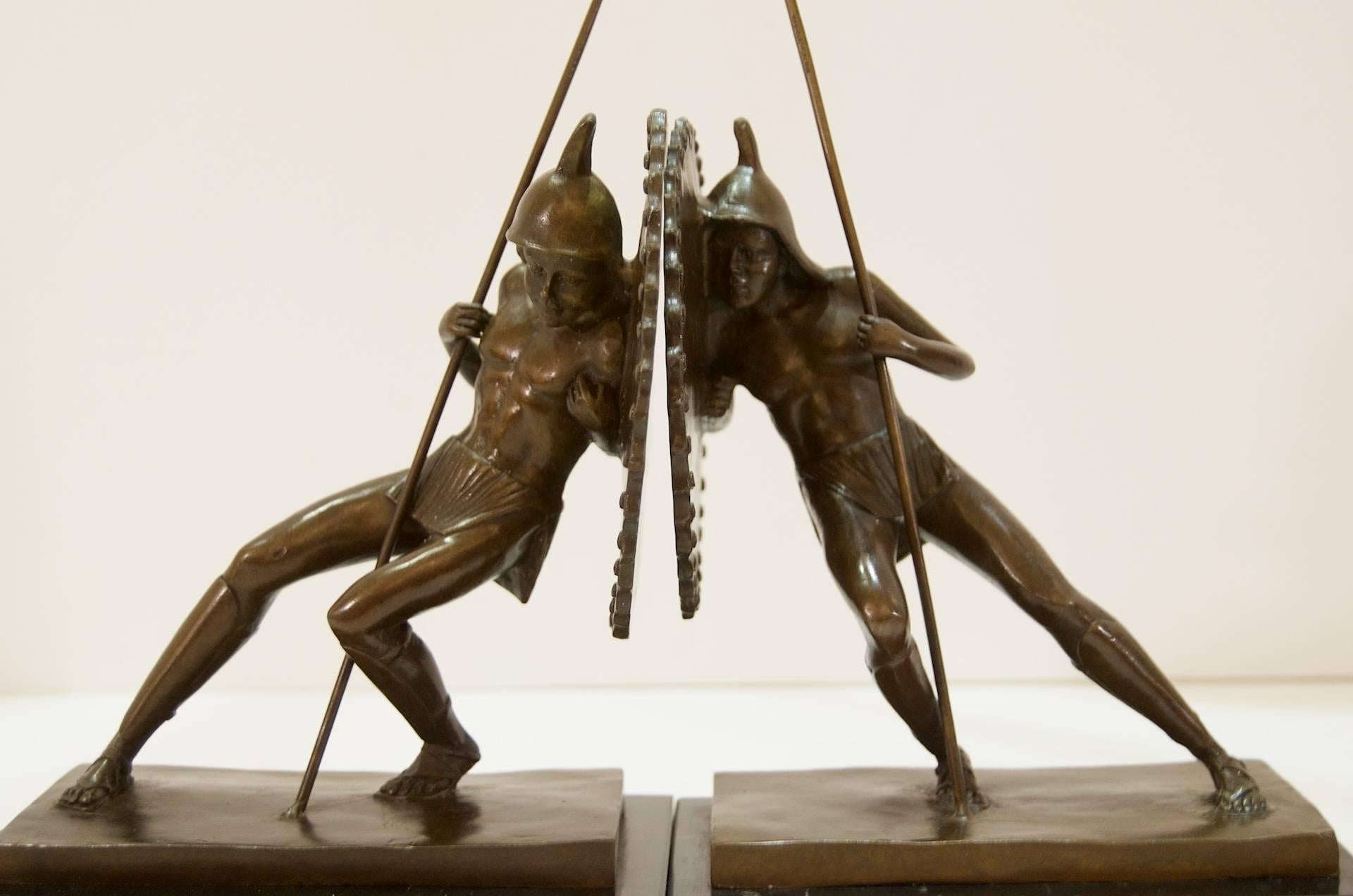 Wonderfully detailed sculptural bookends of gladiators or Greek Hoplites in bronze, mounted on marble bases.