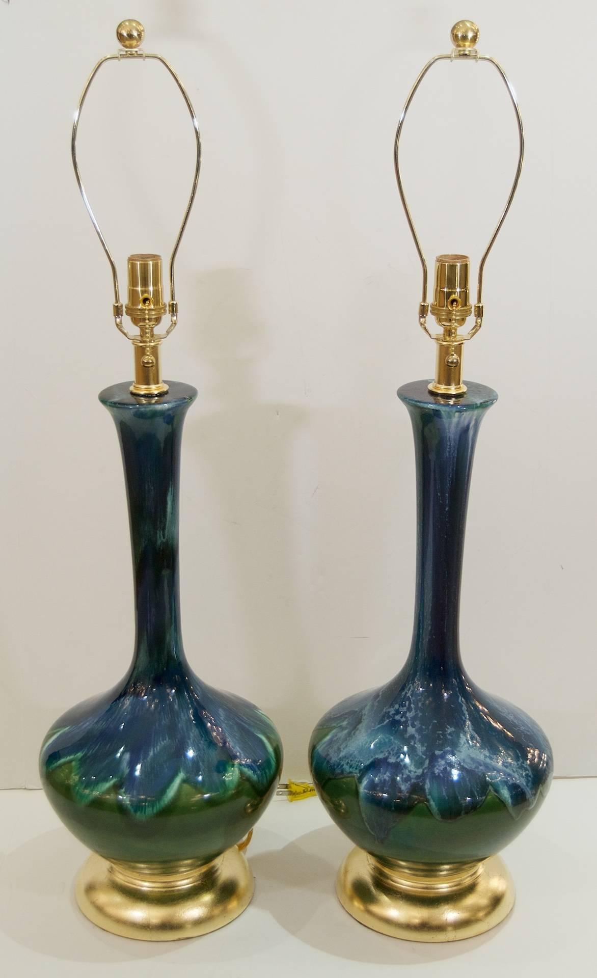Excellent pair of elegantly formed Mid-Century glazed ceramic lamps, with gilt hardware. Some variations in glaze pattern exist between the lamps.

New wiring.

Overall height to the top of the harp using 10