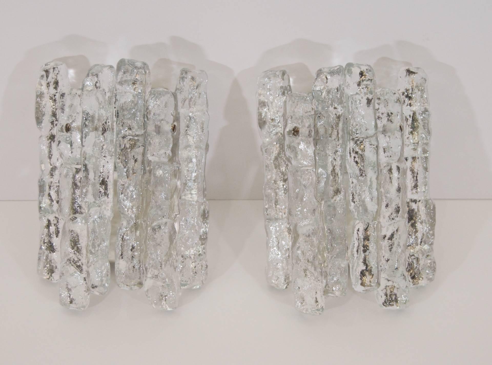 Excellent Kalmar ice glass wall sconces, each having two heavy pieces of ice glass. Petite size will work wonderfully in many spaces, ideal for narrow spaces. 

One E-14 base bulb per sconce up to 40 watts, new wiring.

Please note, price listed is