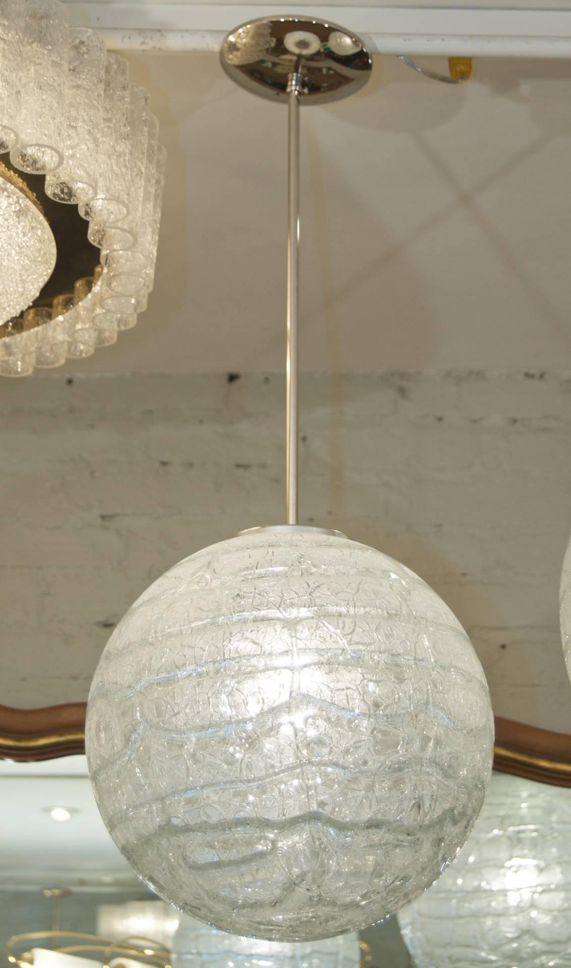 Doria pendant will complement all decors. Heavy textured wave surface glass with crackling and bubbling variegated textures.

Takes a single medium base bulb up to 100 watts, new wiring. Length of drop rod can be adjusted, height listed is of