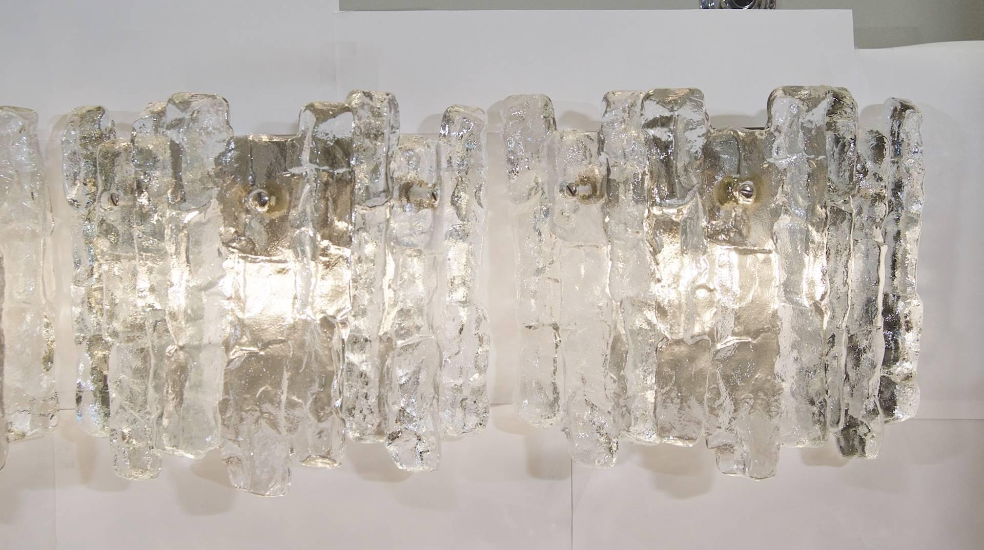 Excellent Kalmar ice glass wall sconces, each having three heavy pieces of ice glass.

Each takes two E-14 base bulbs up to 40 watts per bulb, pictured with 10 watt bulbs. New wiring.

Price is per pair. Three pairs total available.