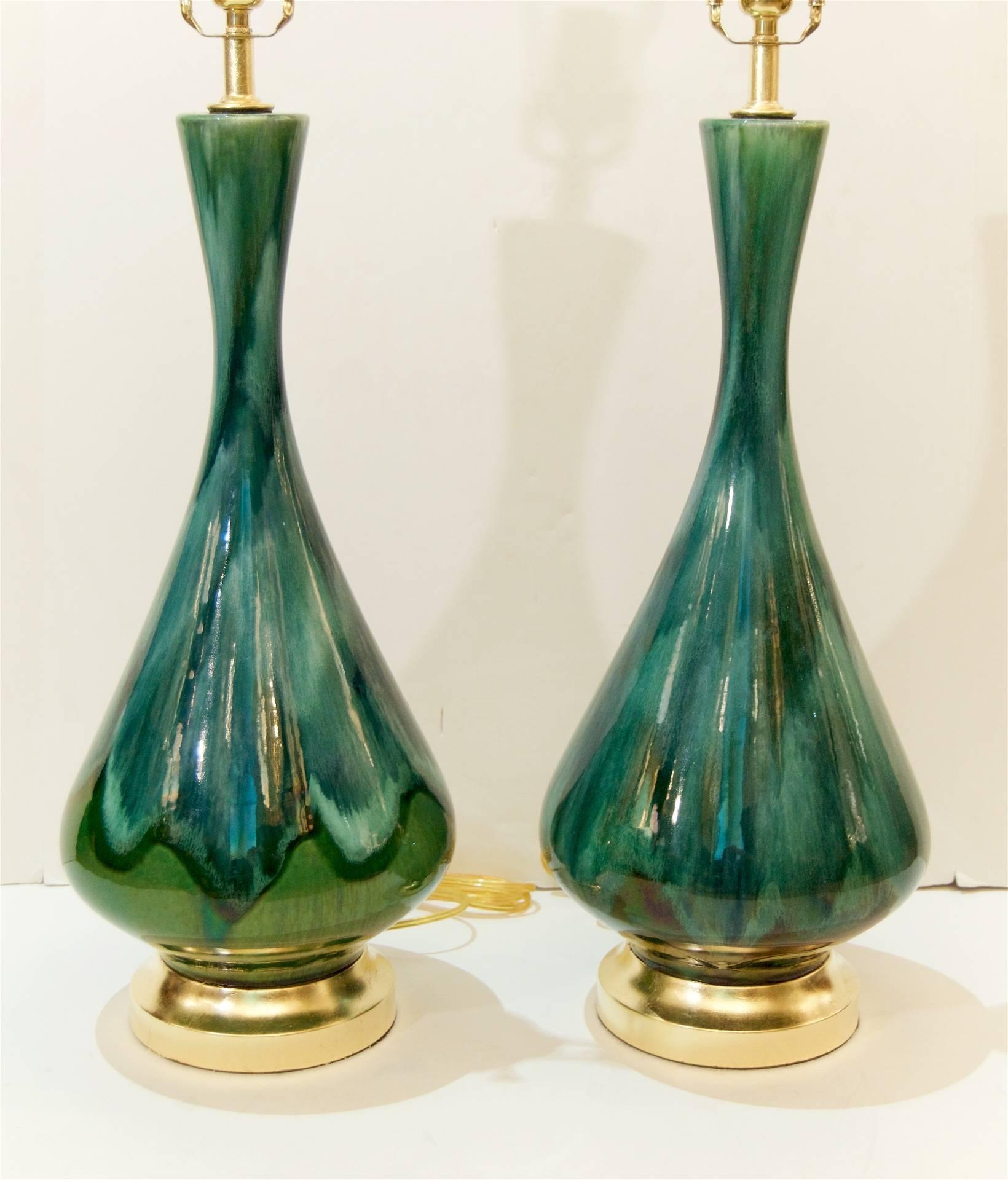 Excellent pair of elegantly formed Mid-Century glazed ceramic lamps with gilt hardware possibly by Royal Haeger.

New wiring. Lamp shades are for display purposes only and are not included.

Overall height to the top of the harp using 11