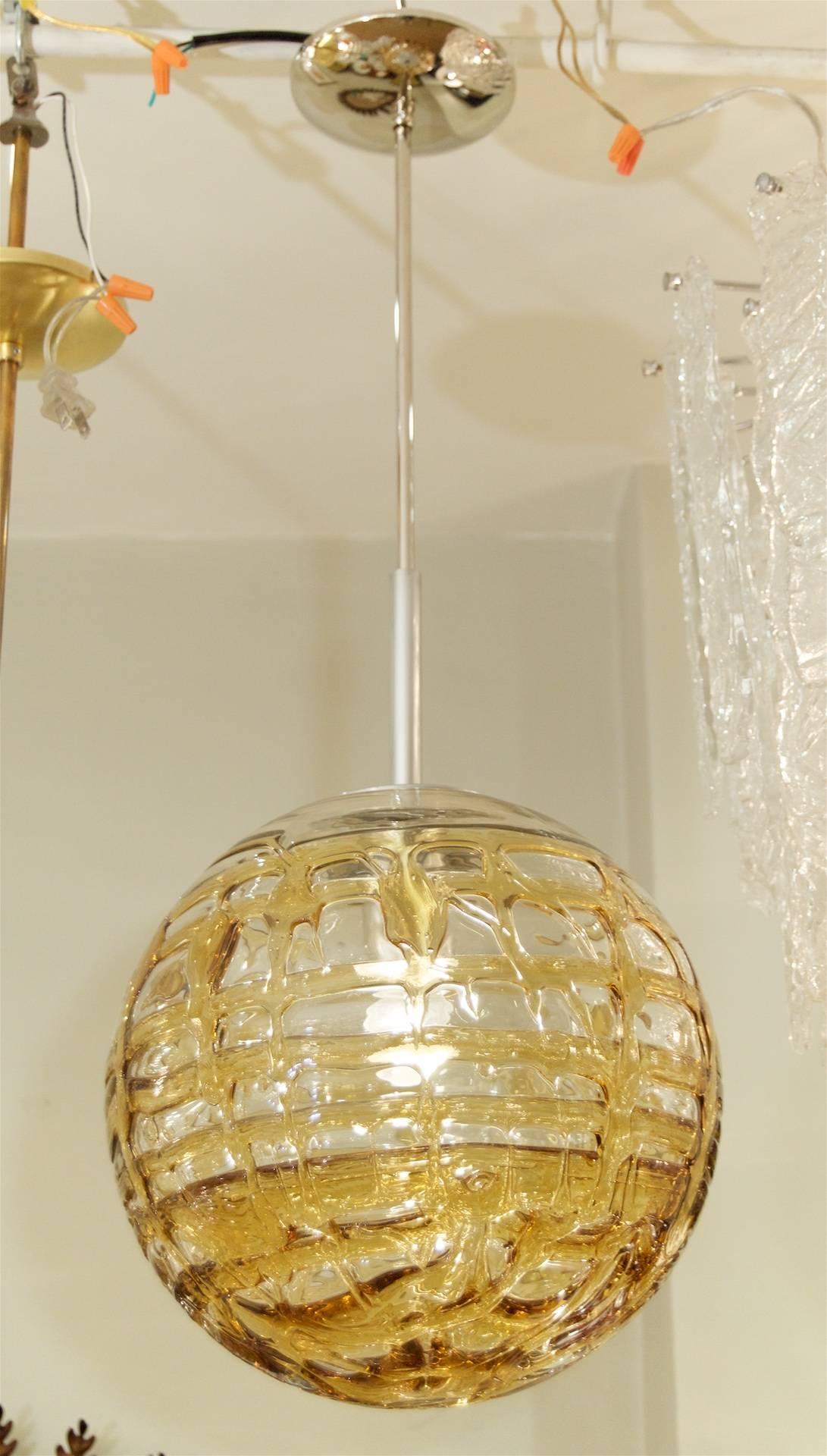 Fantastic Doria pendant will complement all decors. Heavy textured wave surface glass with gold tints infused in the waves, variegated from clear areas.

Takes a single medium base bulb up to 100 watts, new wiring. Please know height listed is of