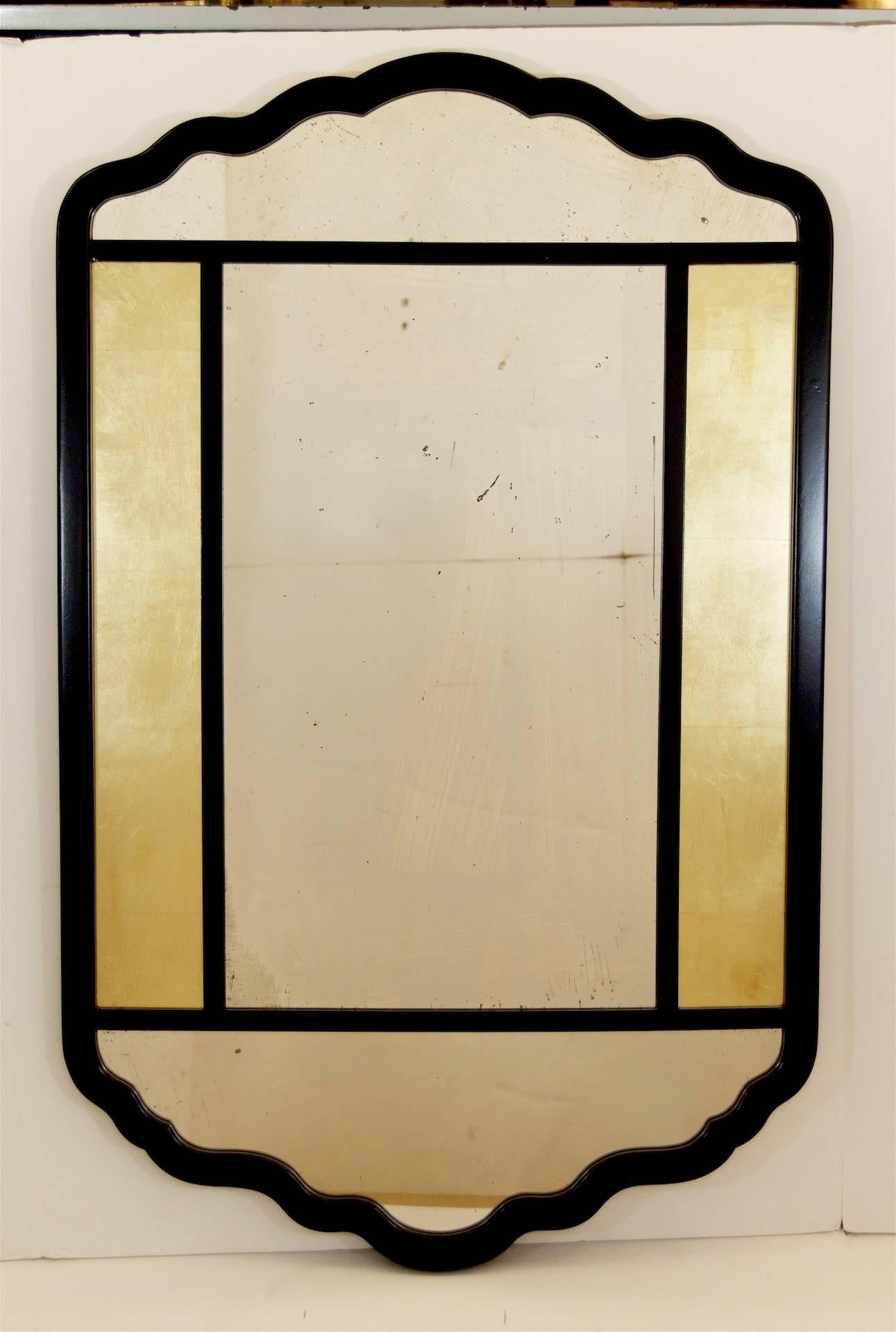 Paneled mirror with ebonized frame and églomisé́ side panels.
