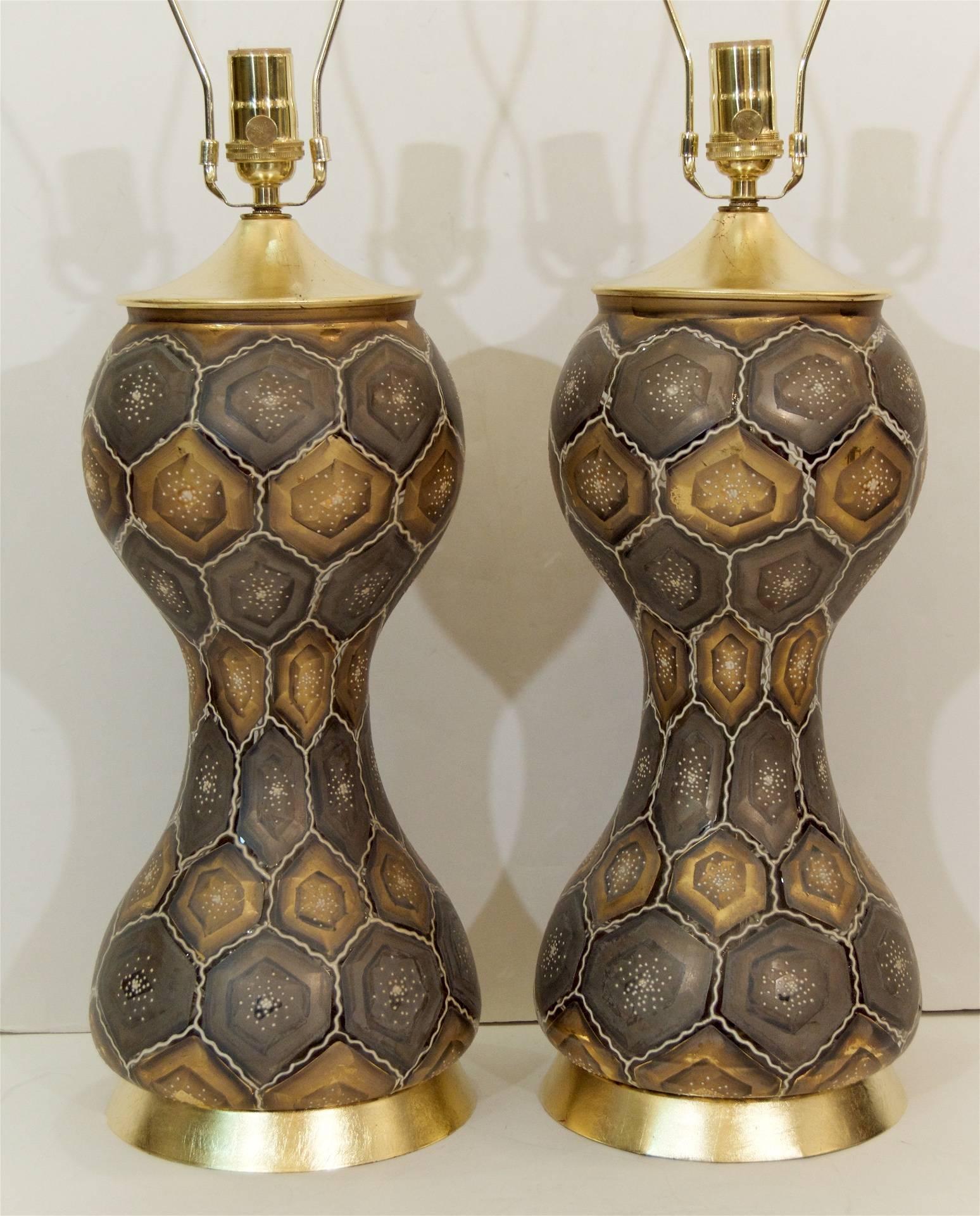 Unique pair of honeycomb patterned gold and silver painted glass table lamps on gold leaf bases.

Each lamp takes one medium base bulb up to 150 watts per bulb. New wiring, three way sockets.

Height listed is including a 9" harp, height to the