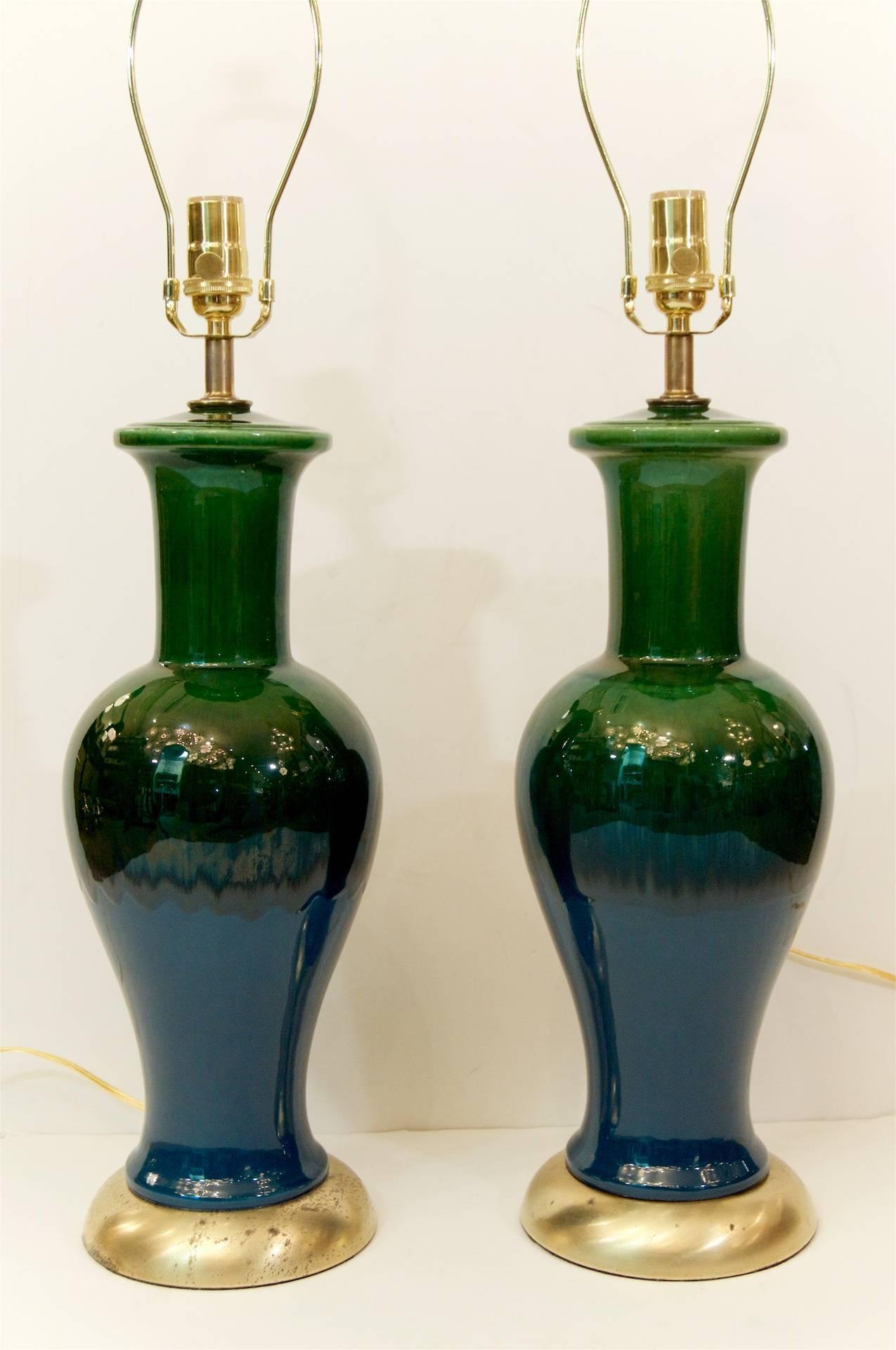 Excellent pair of elegantly formed Mid-Century glazed ceramic lamps, with gilt hardware. Some variations in glaze pattern exist between the lamps.

Height listed is to the top of a 9 inch harp, height to the top of the socket is 23 inches.