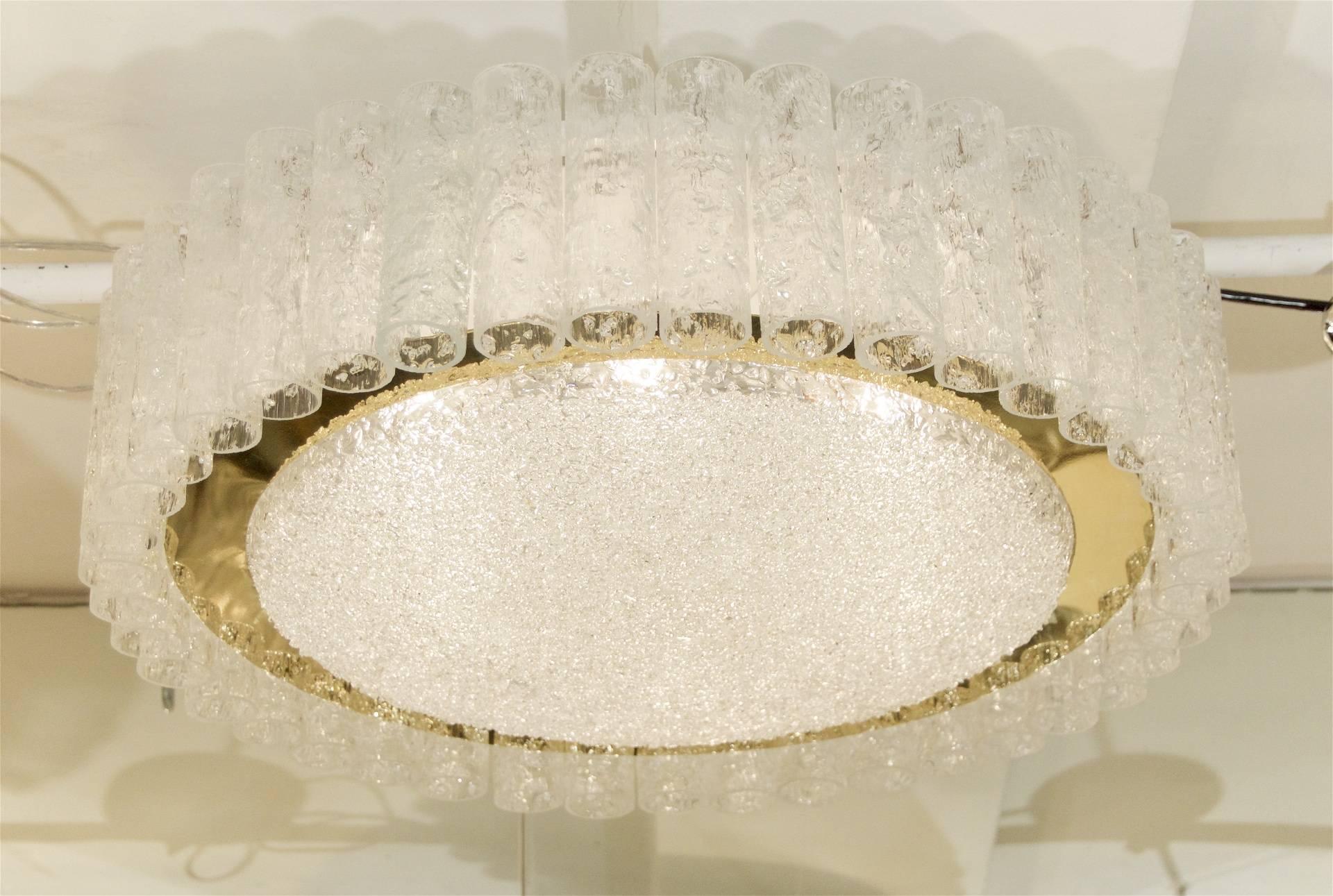 A gorgeous and unusually large Doria ceiling light, with individually hung organic ice glass tubes surrounding a brass ring and inner ice glass disk.

Six medium base bulbs up to 60 watts per bulb. New wiring.

 