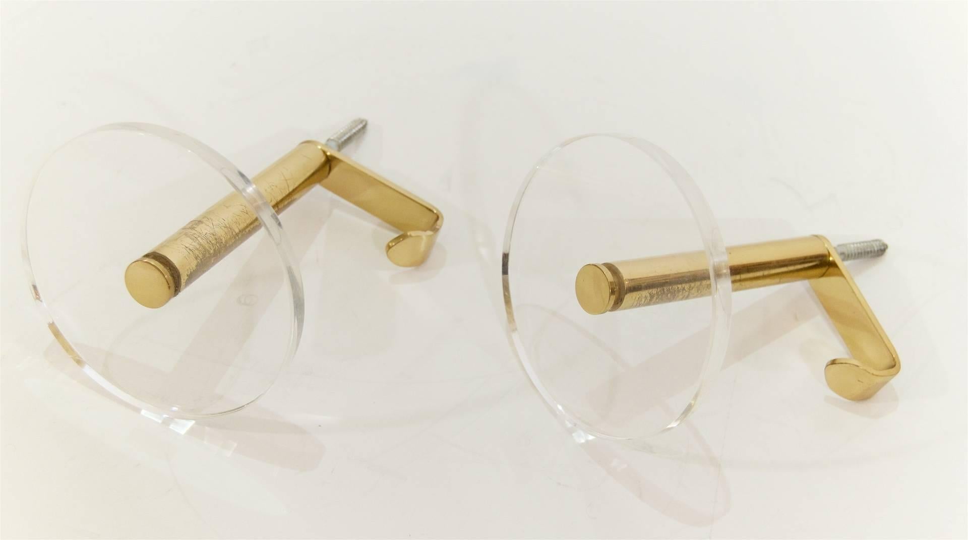 Pair of Minimalist brass coat hooks with Lucite disk accents.