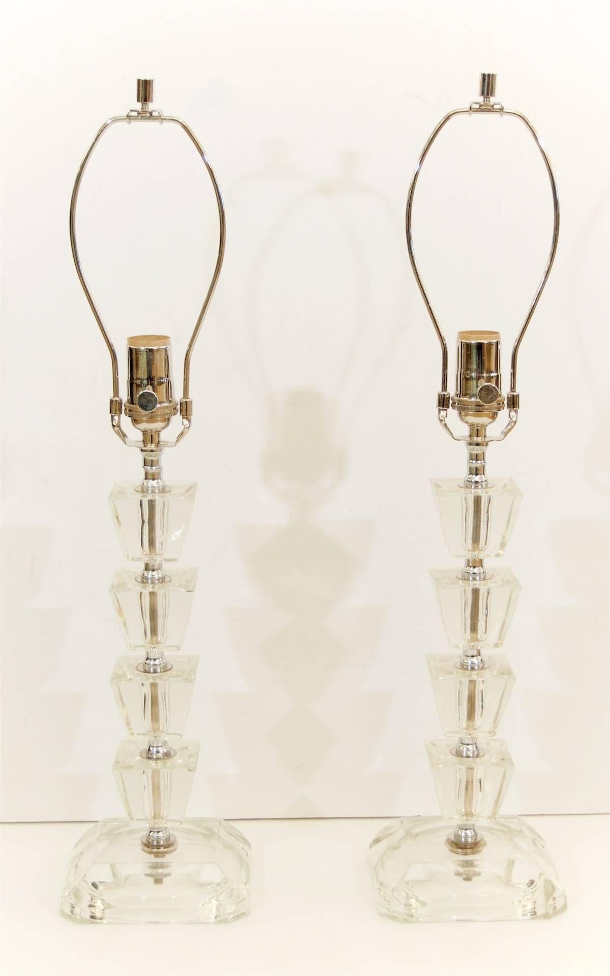 Pair of elegant boudoir lamps, each lamp is comprised of four trapezoidal pieces of crystal separated by chrome spacers on a beveled base.

 Height listed is to the top of a nine inch sharp, height to the top of socket is 16.25 inches.