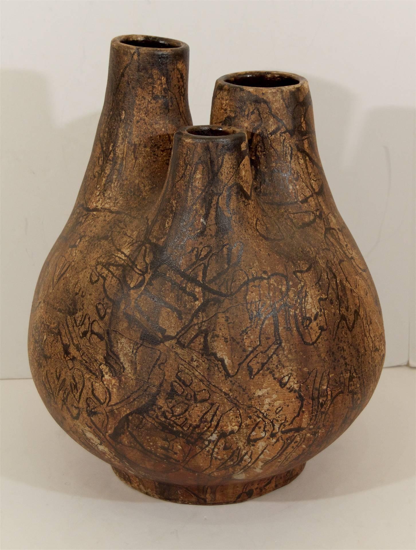 An unusual designed vase with brown glaze and a black organic design.