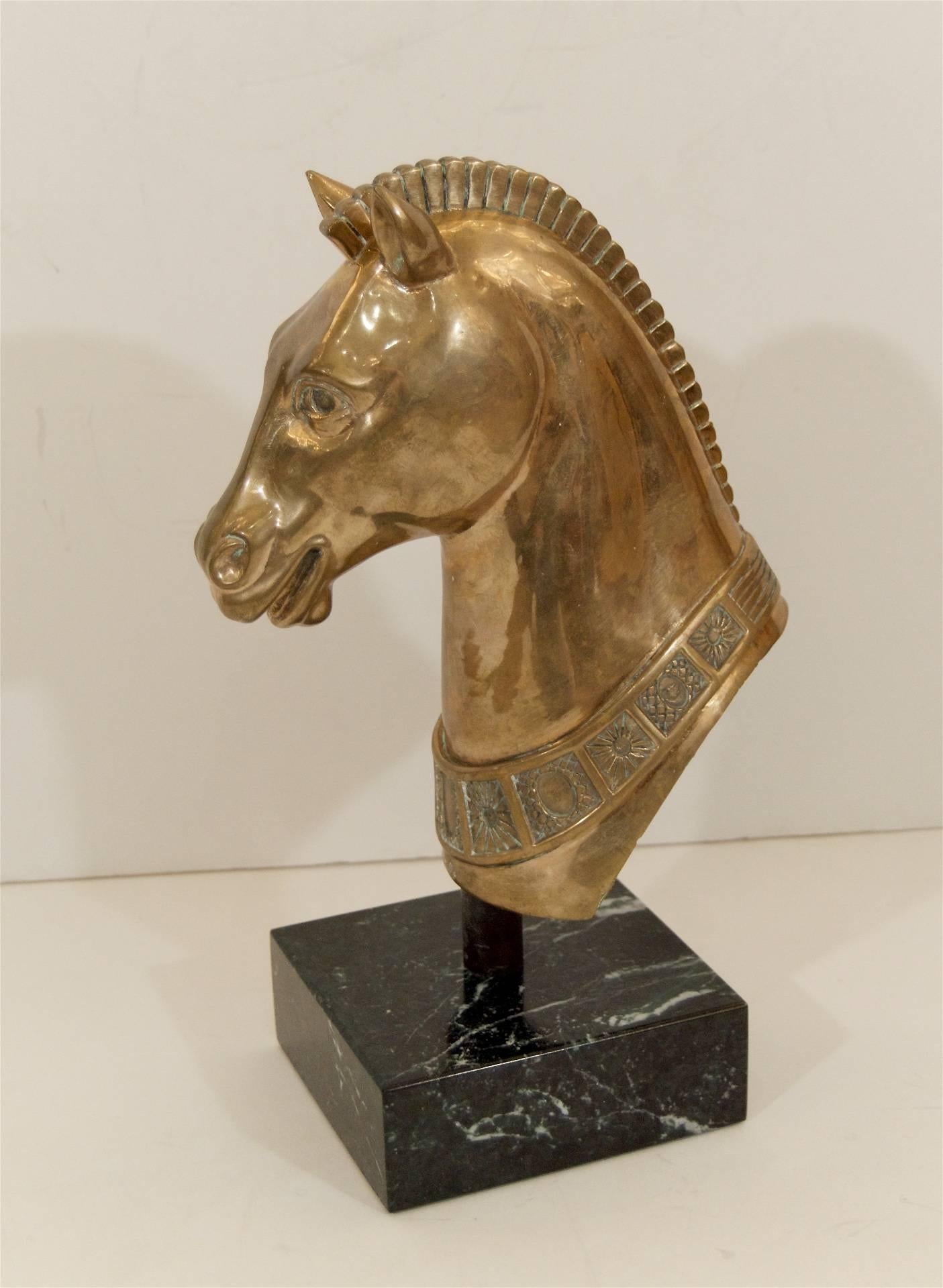 Well detailed solid brass sculpture of a horse head on a marble base.

