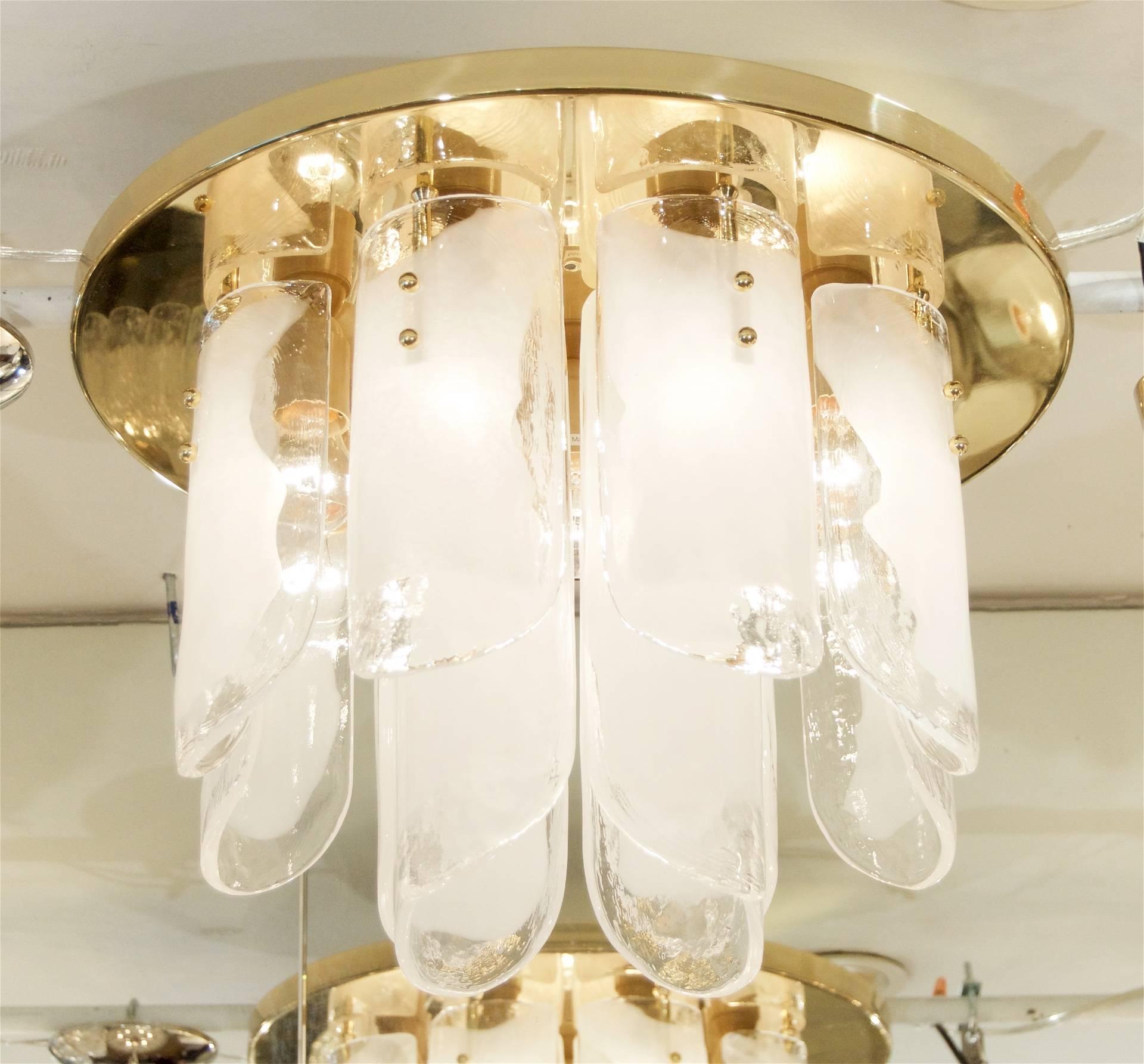 Beautiful Kalmar flush mount chandelier, comprised of two tiers of organic blown glass with opaque white glass centers on a circular brass backplate. 

Takes 9 medium base bulbs up to 60 watts per bulb.