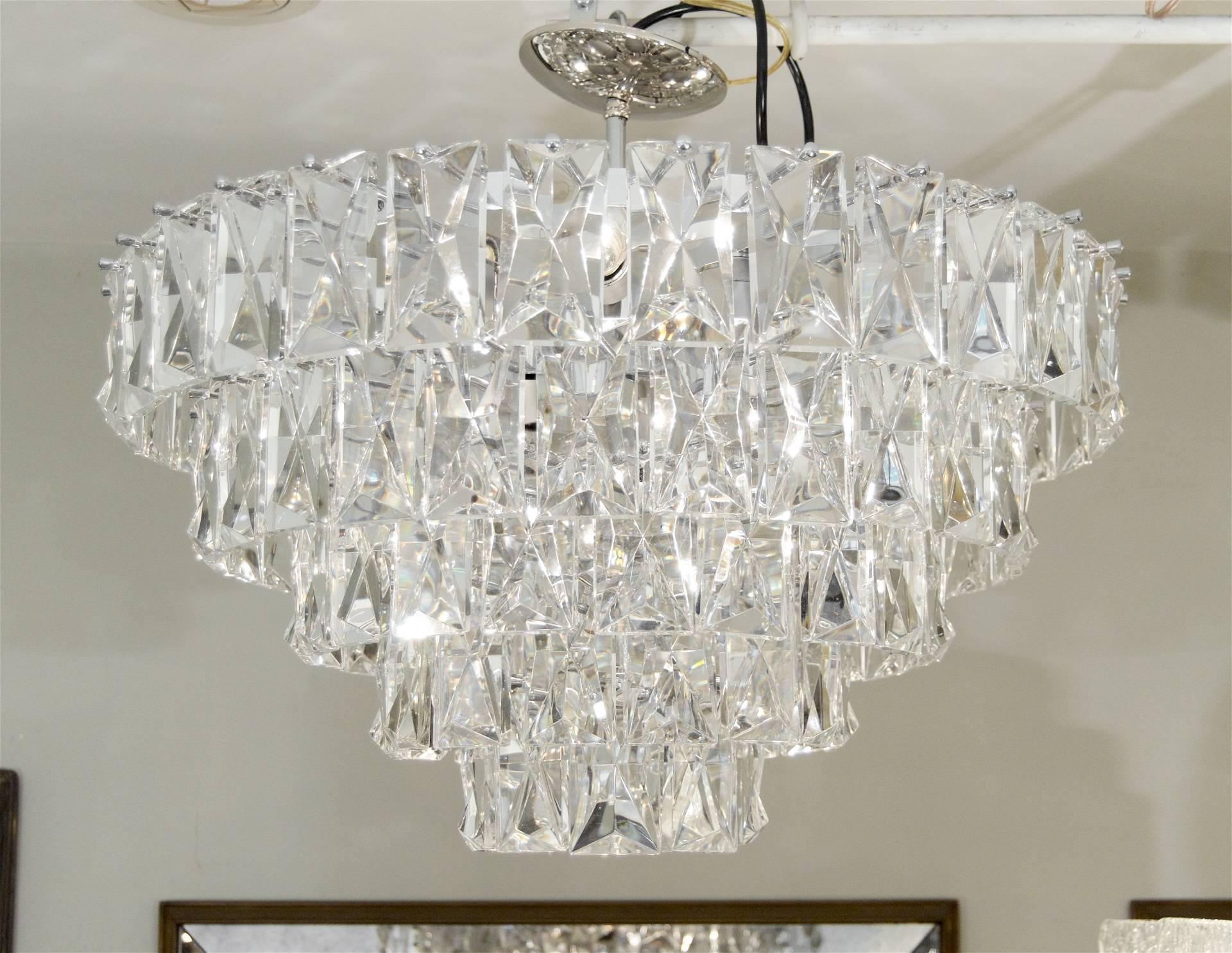 An unusually large chandelier comprising five tiers of faceted rectangular crystals. Both imposing and beautiful, suits a wide variety of decors and is well suited in size for a grand statement.

Takes 13 medium base bulbs up to 60 watts per bulb,