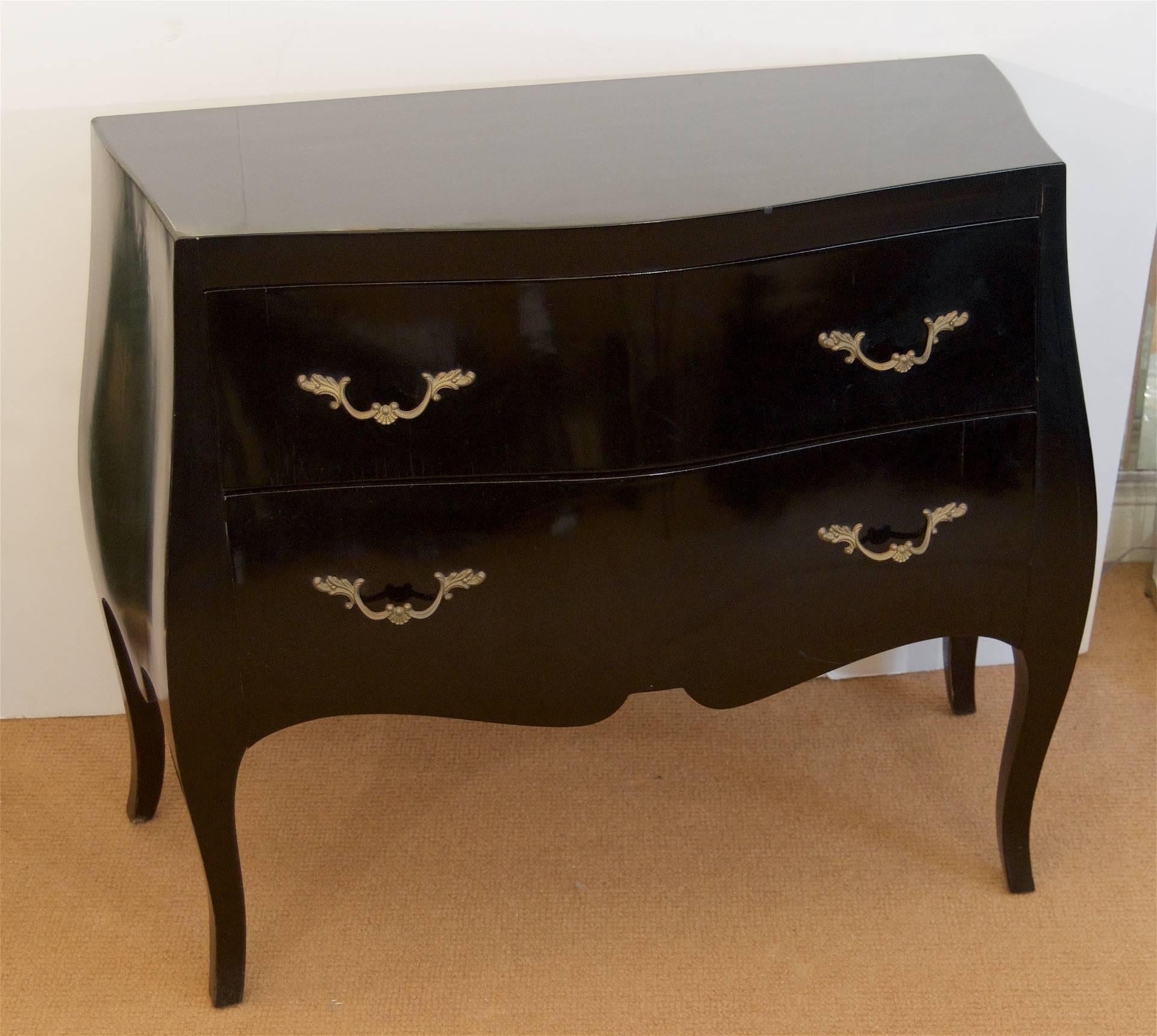 Beautiful black lacquered bombe chest with brass pulls. Interiors lined with fleur-de-lis paper.