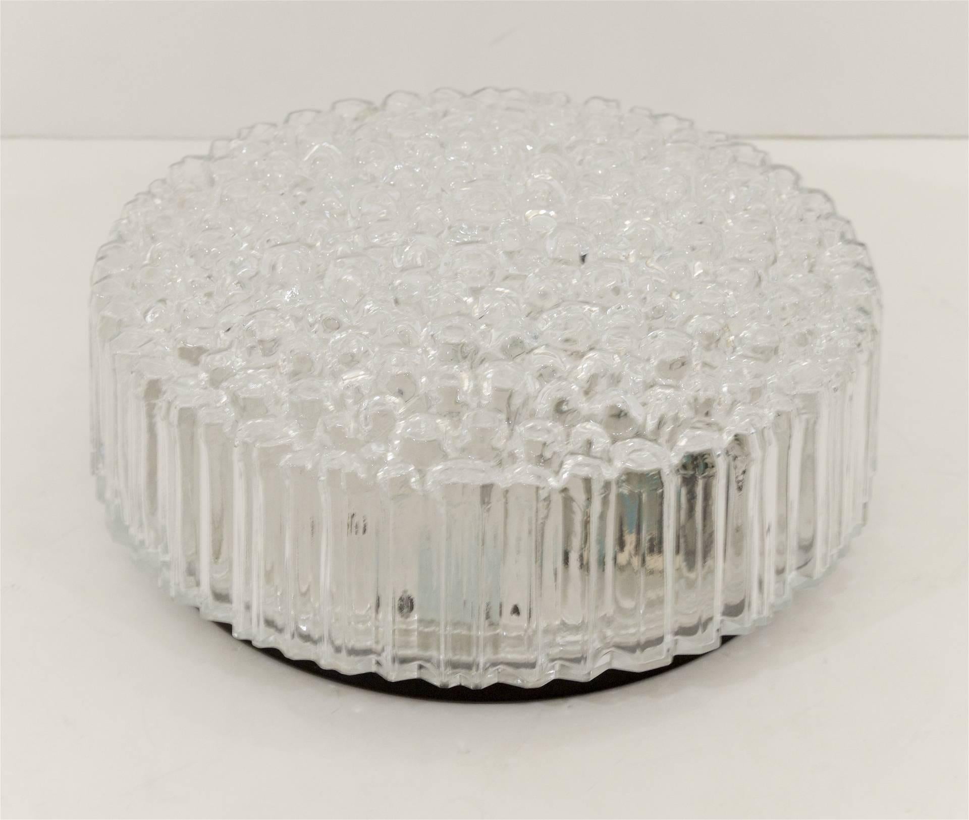 A beautiful glass flush mount with a raised etched glass bubble pattern with singular cuts on the side to create a linear pattern.

Takes one medium base bulb up to 60 watts, new wiring.