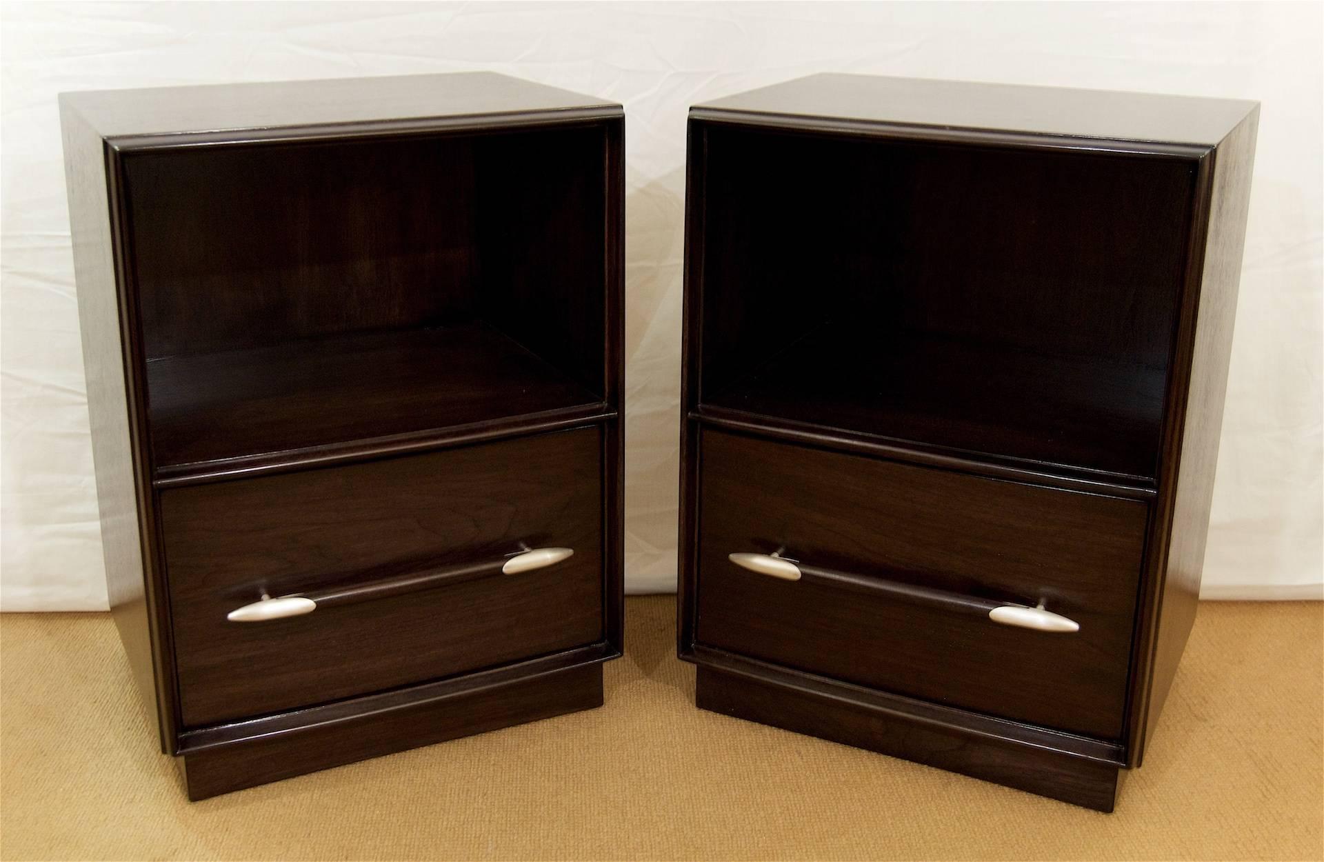 Pair of newly ebonized nightstands, satin varnished, designed by T.H. Robsjohn-Gibbings for Widdicomb. 

Each nightstand has a well sized drawer with an elongated ebonized wood handle capped with brushed chrome accents.